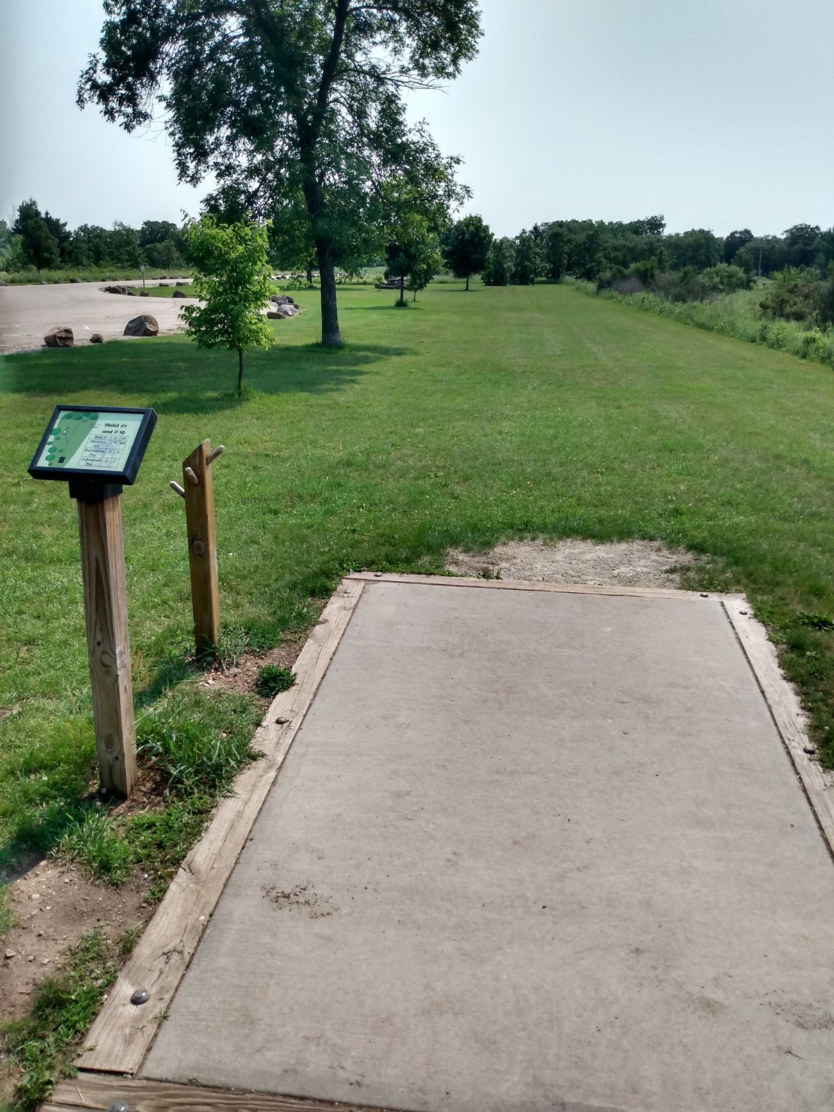 Hole 1 is the short basket to the left and elevated on the rock pile. Hole 10 is long and straight ahead.