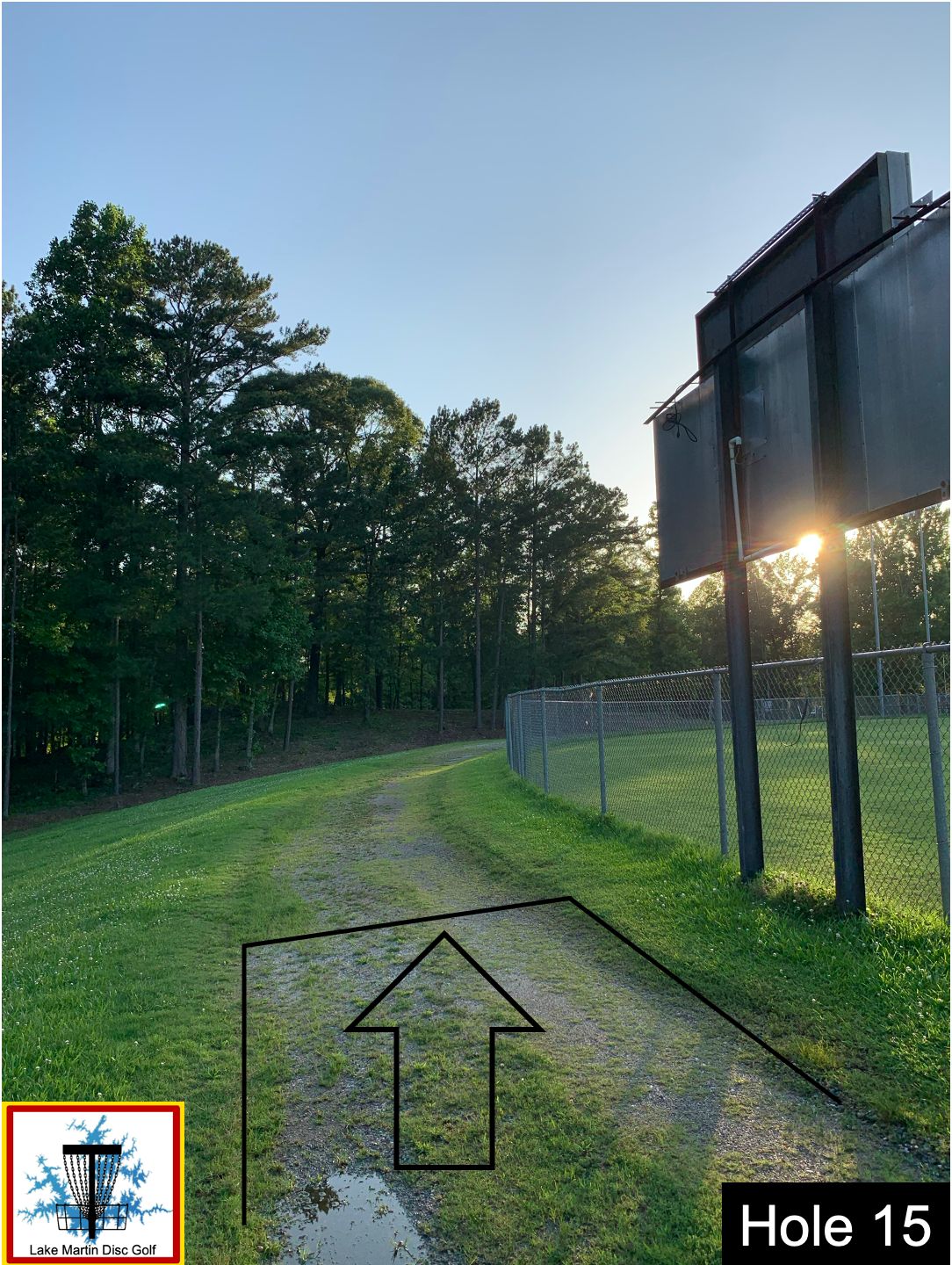 back of the baseball field scoreboard uphill from the 8 hole course 9th hole fairway to 8th basket