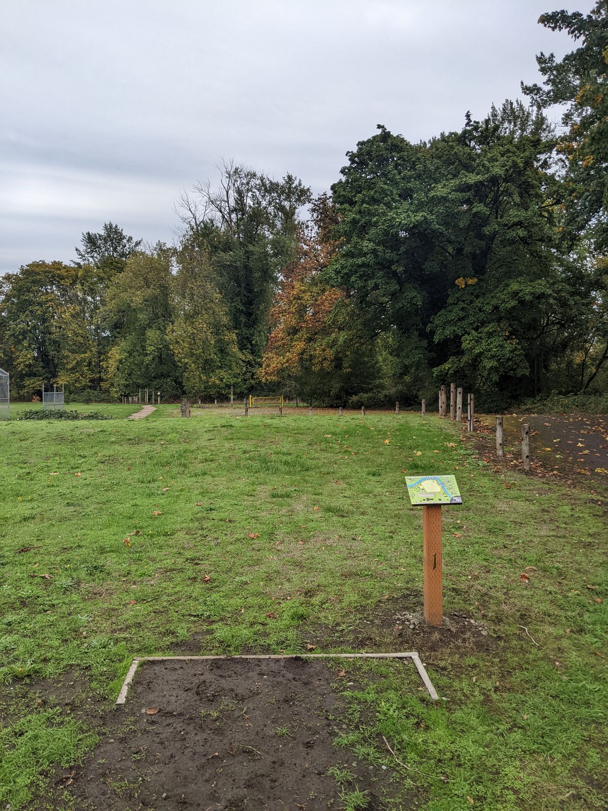 Tee box 1.

Basket is past yellow gate and to the right.

Am: no OB
Pro: area R of fence line and before gate is OB UNLESS there are mixed use ballfield presence.