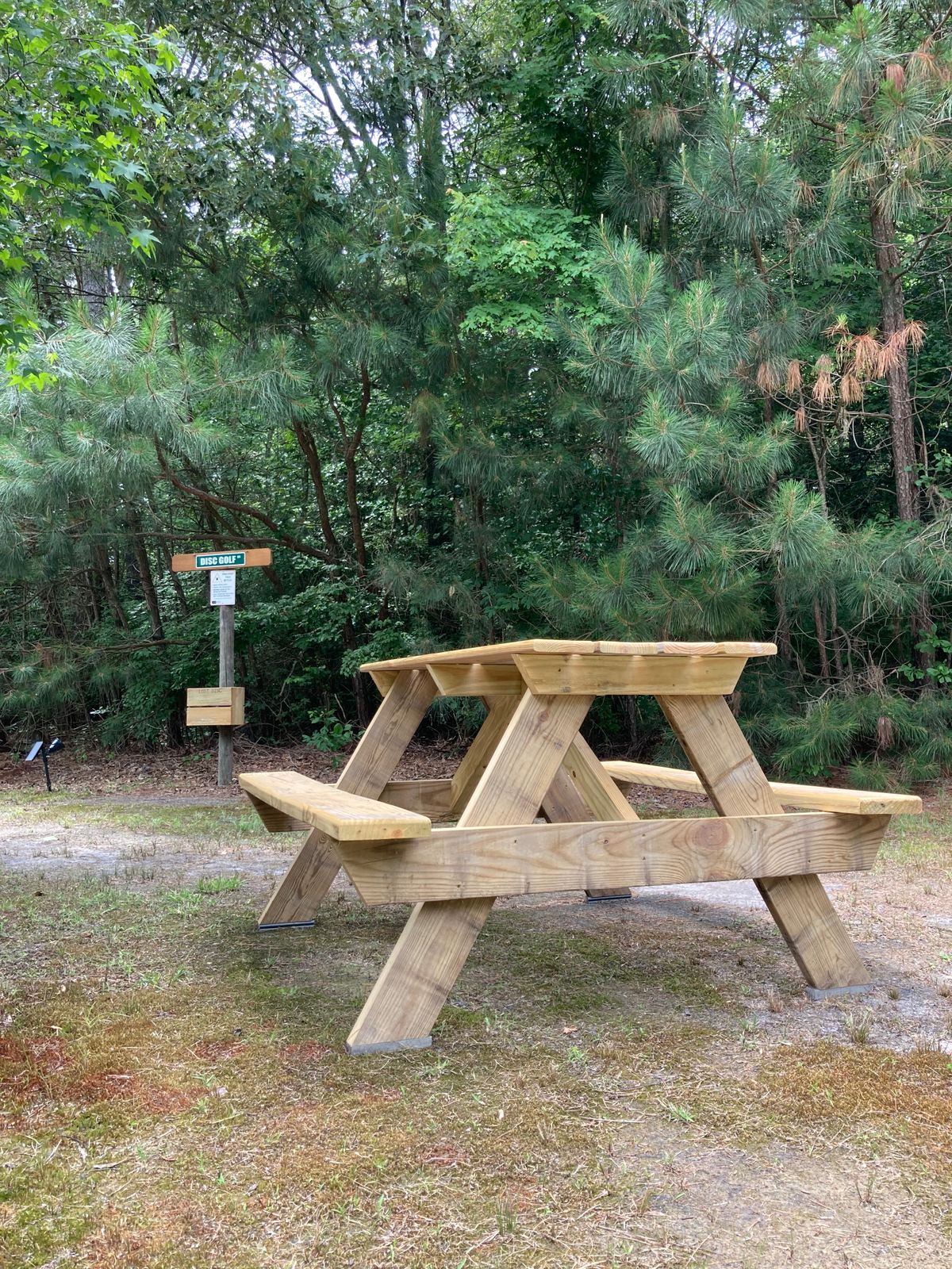 New picnic table in front of clubhouse, made with leftover materials.