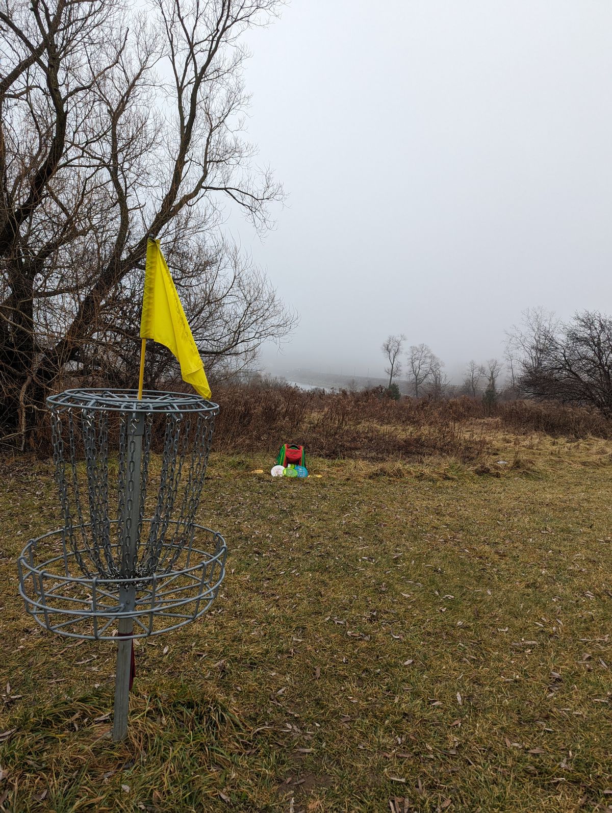 Foggy view of the dam from hole 6 basket during a warm December 2023
