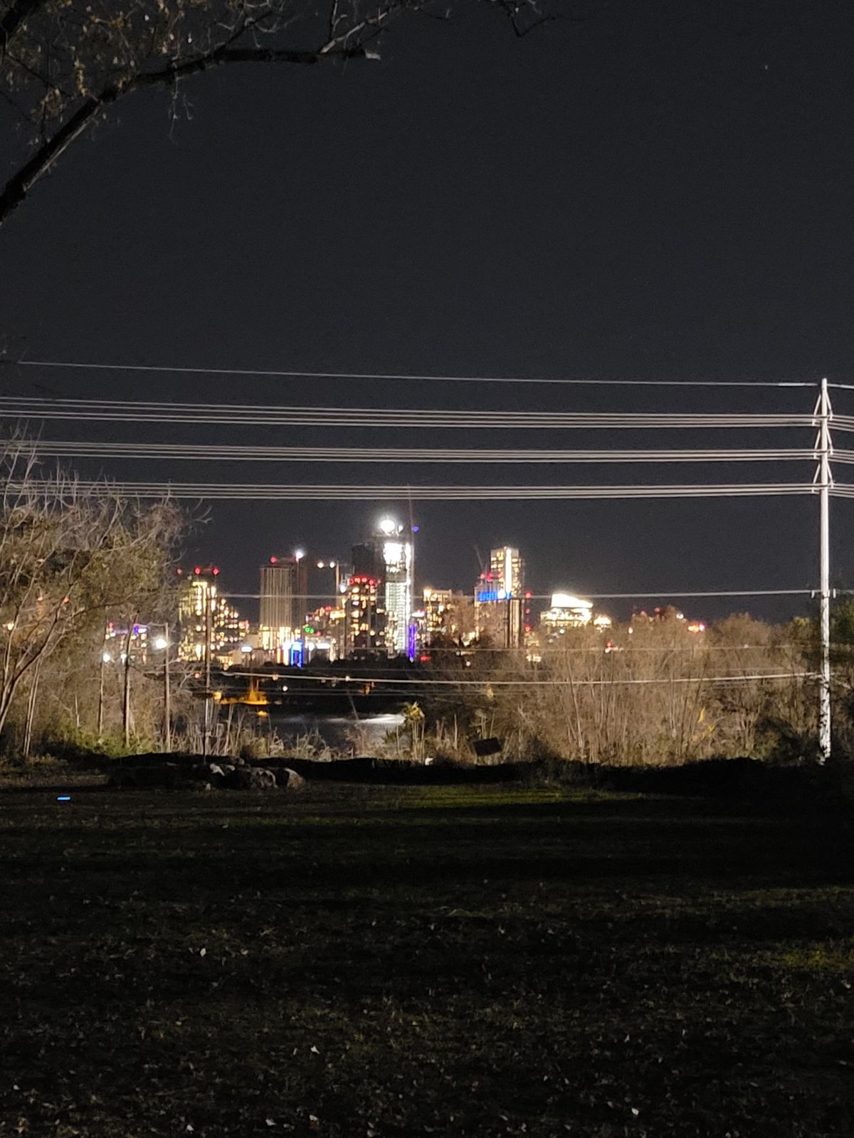 # 6 lit up; disc lit up with Ladybird lake and nightlife Austin in the background.