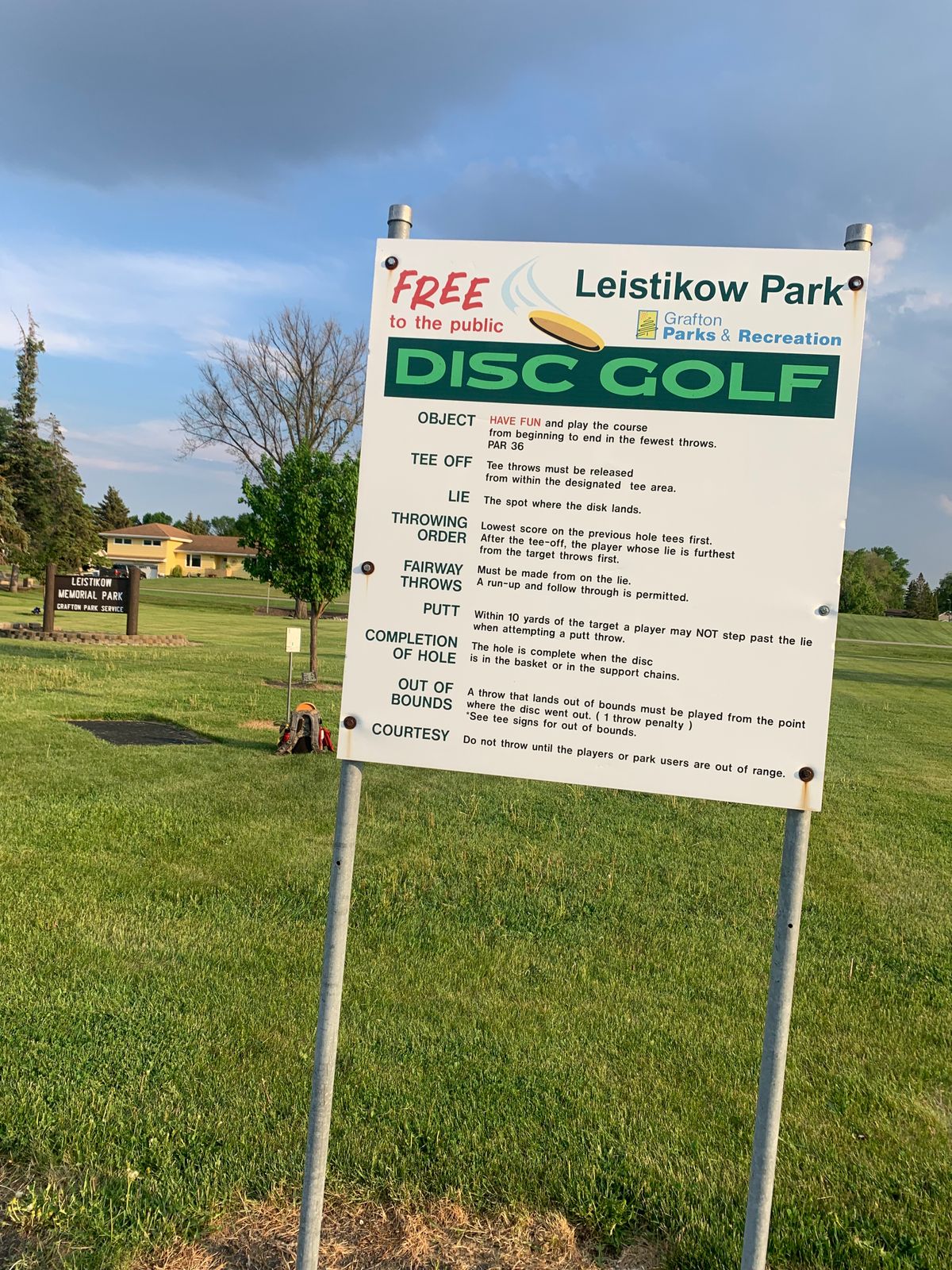 Course sign. Hole 1 tee pad in background.