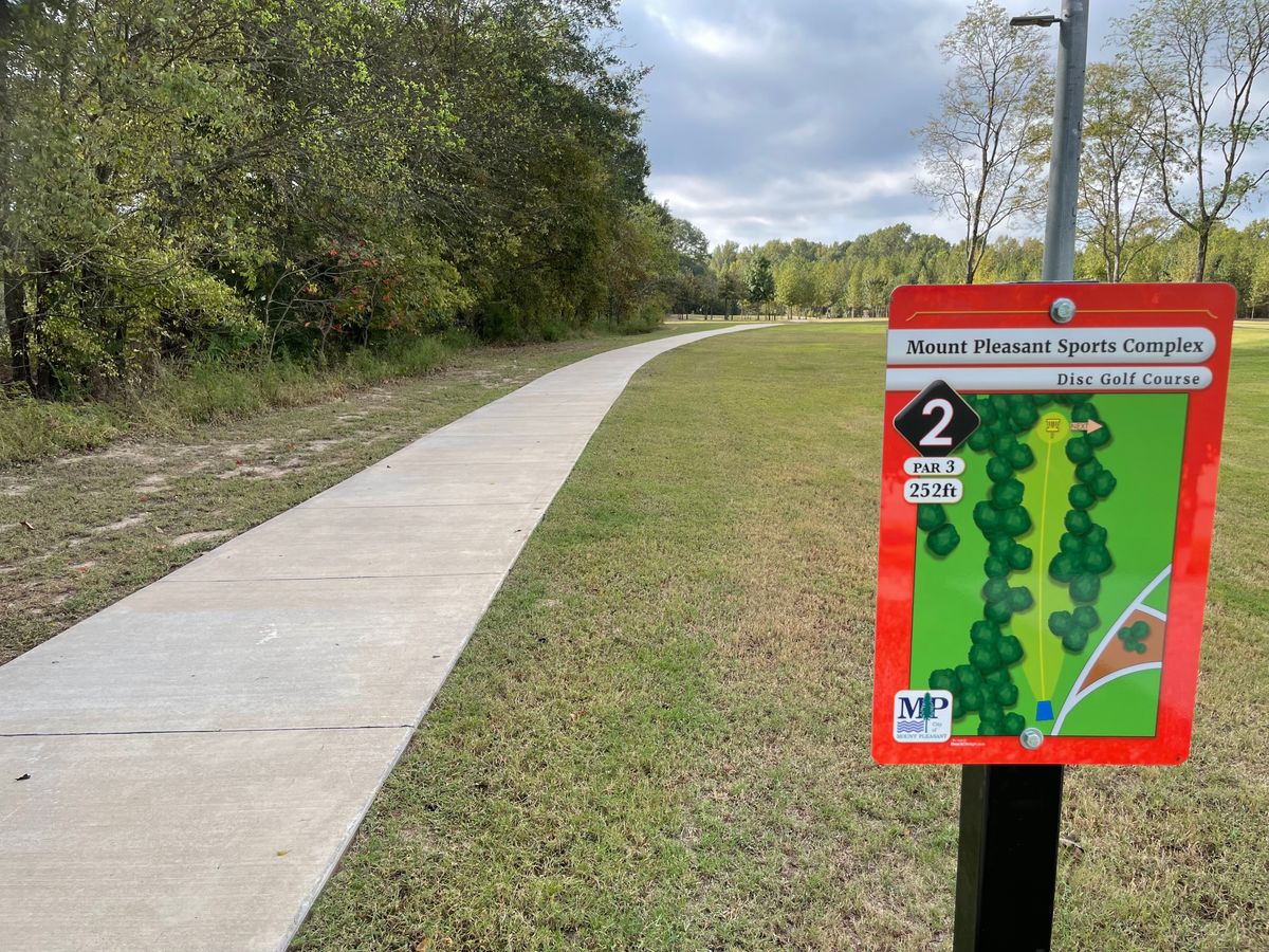 Hole 2’s tee is off of what the sign depicts.  Careful as you will be throwing over Hole 1’s basket