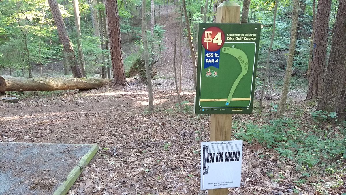 Hole #4. Par 4 - 455 Feet. Big dogleg left uphill, then sloping steeply downhill to basket. Water behind basket.