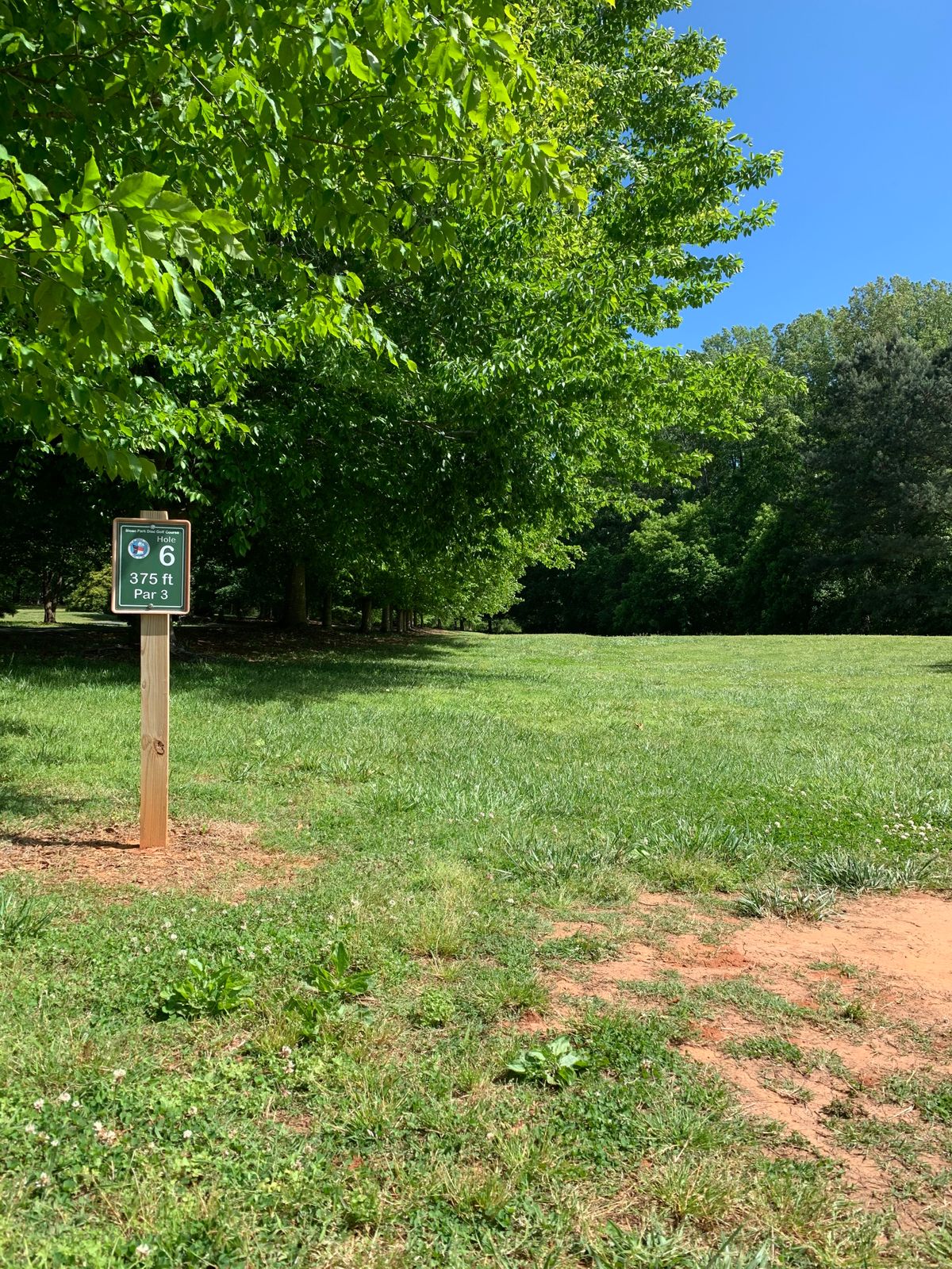Hole 6 - Truthfully uphill. Basket nestled just inside the woods to the right.