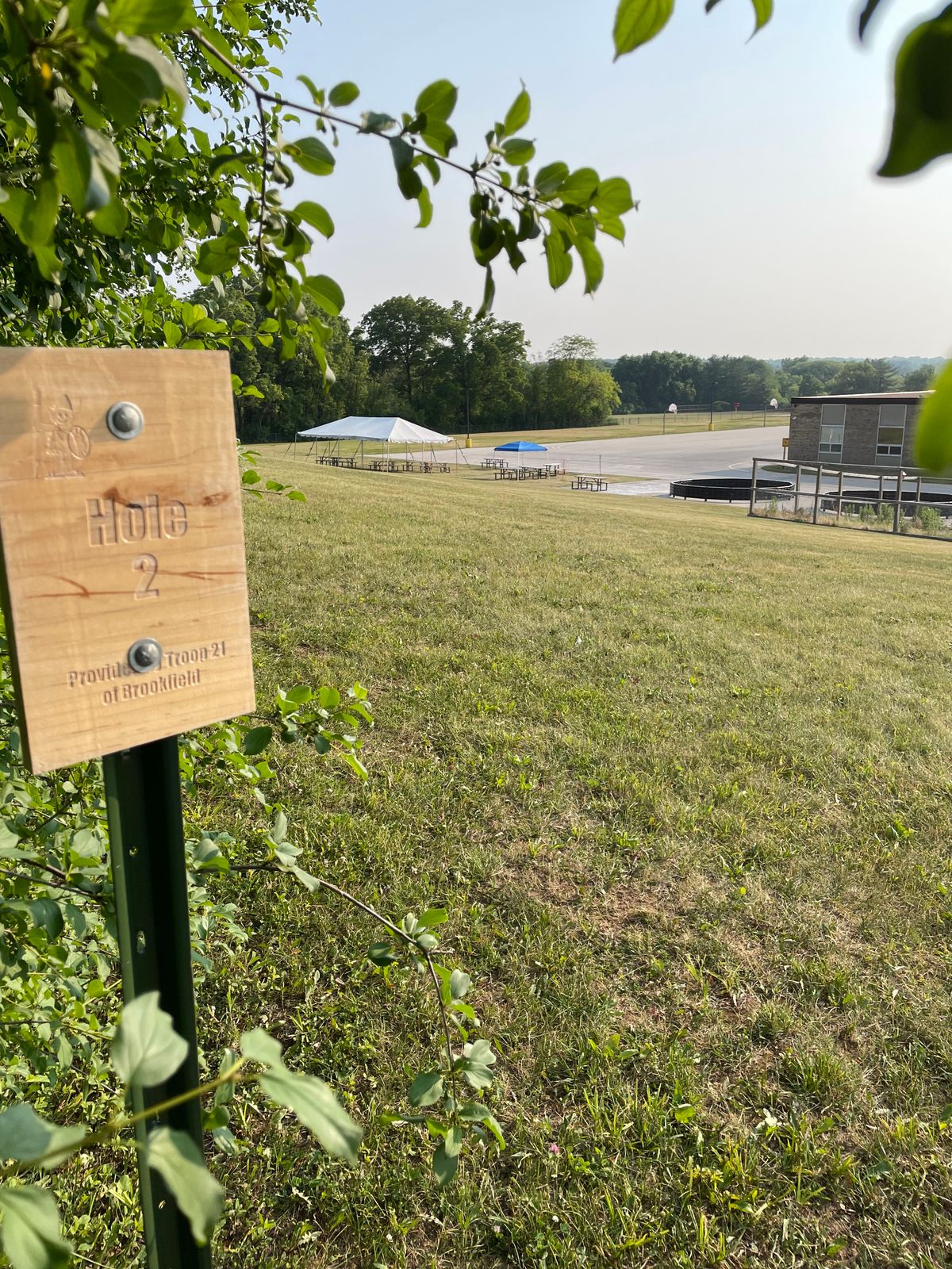 2 - Back downhill; basket is by the blue tent (appears temporary).