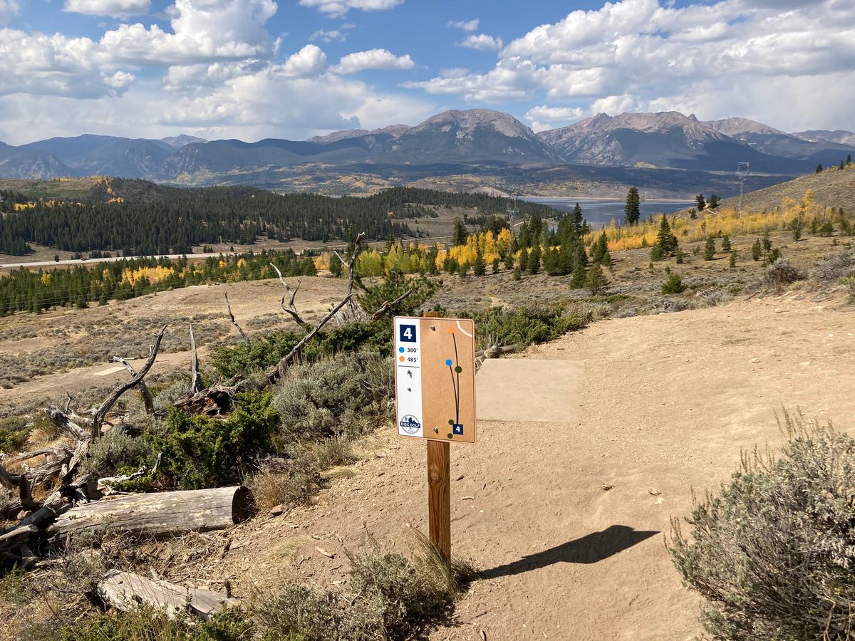 Hole 4 with aspen leaves changing. Looking west at The reservoir and mountains.