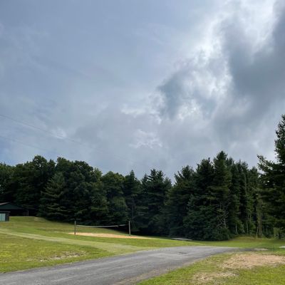 Hole 18 tee. Landing zone is down hill beyond the volleyball court.