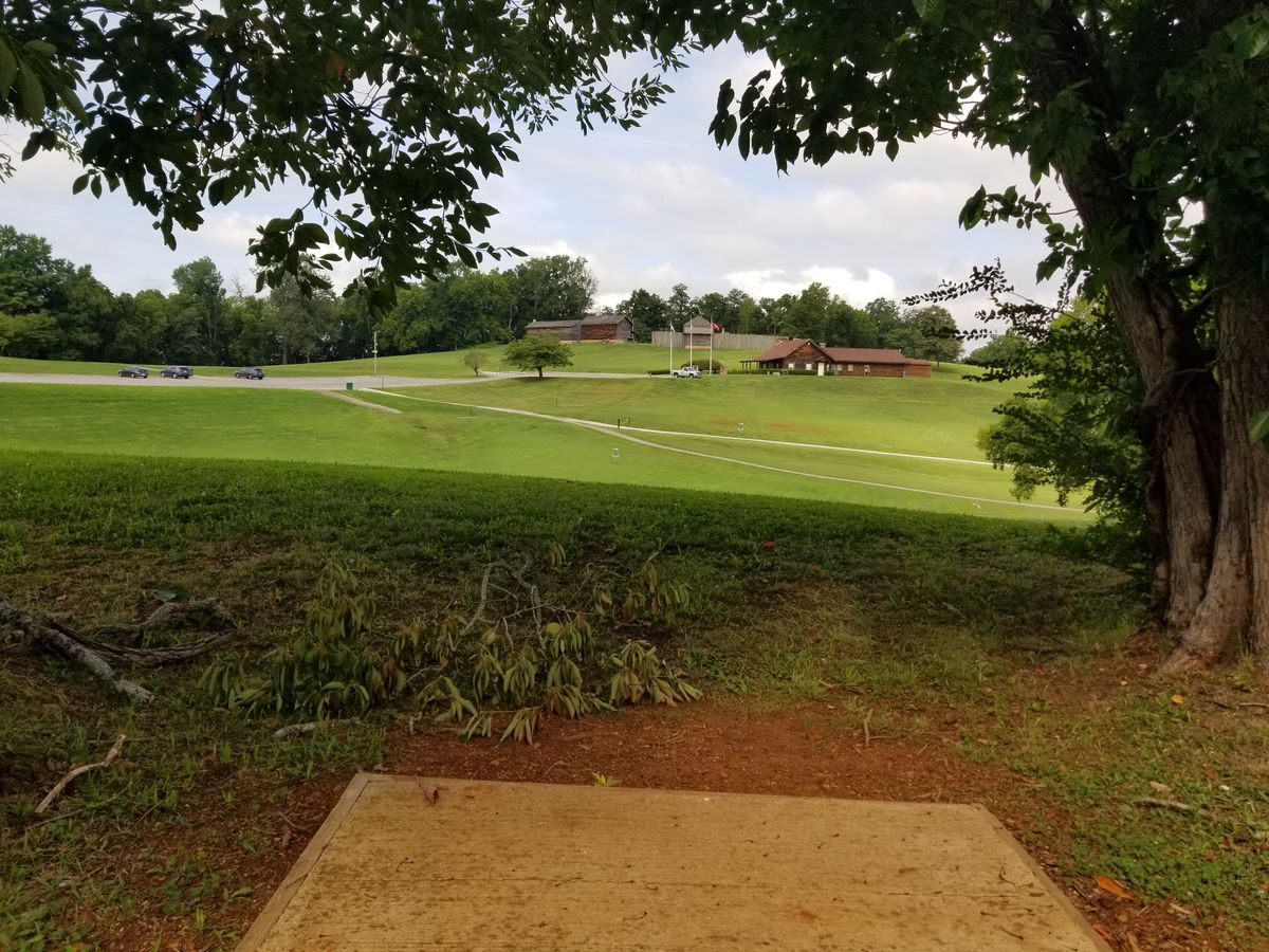 Tee pad #2.  Looking down at basket. Fort and visitor's center in background