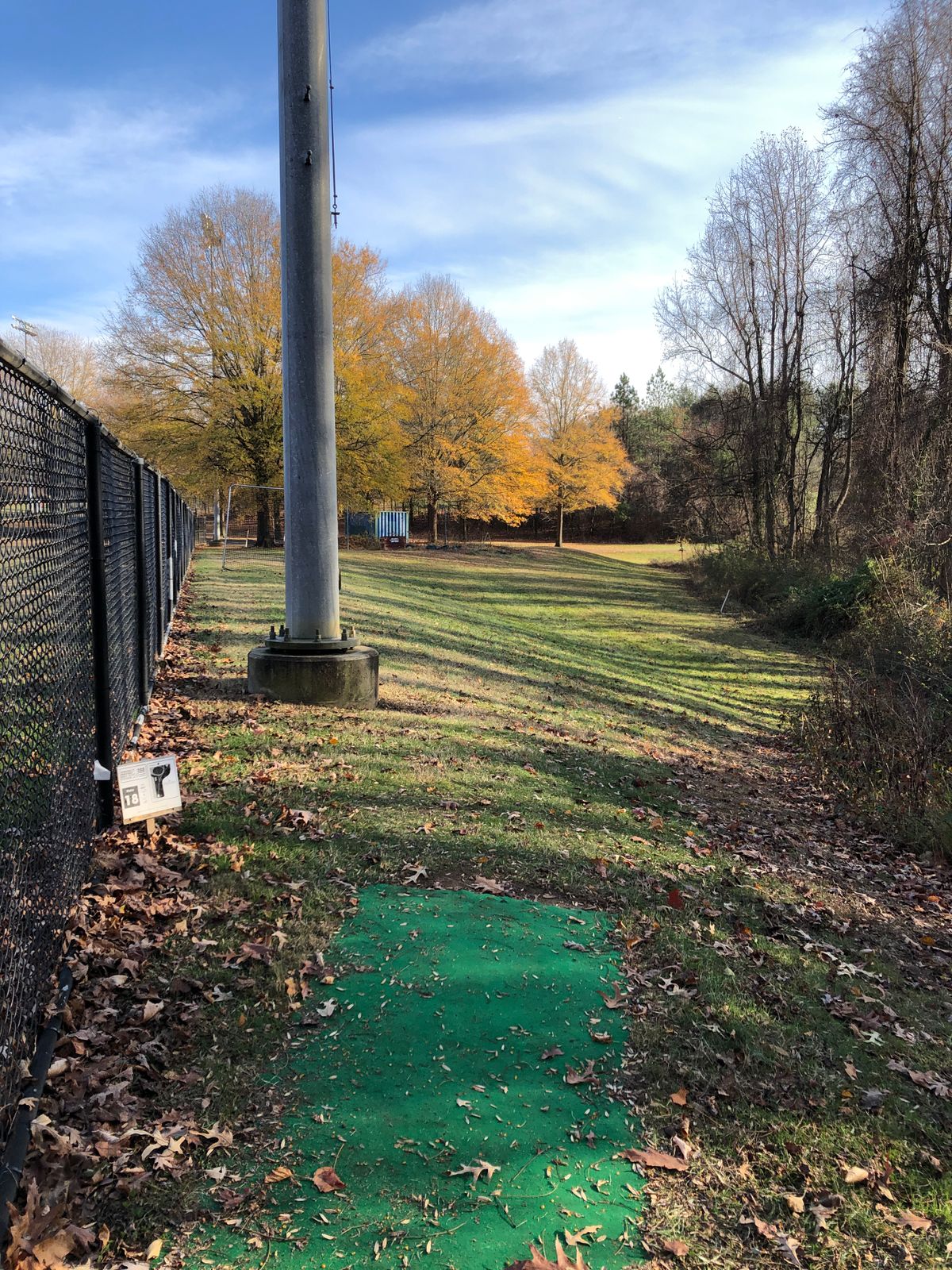 Hole 18 tee (OB field and container on left; OB path long and left)