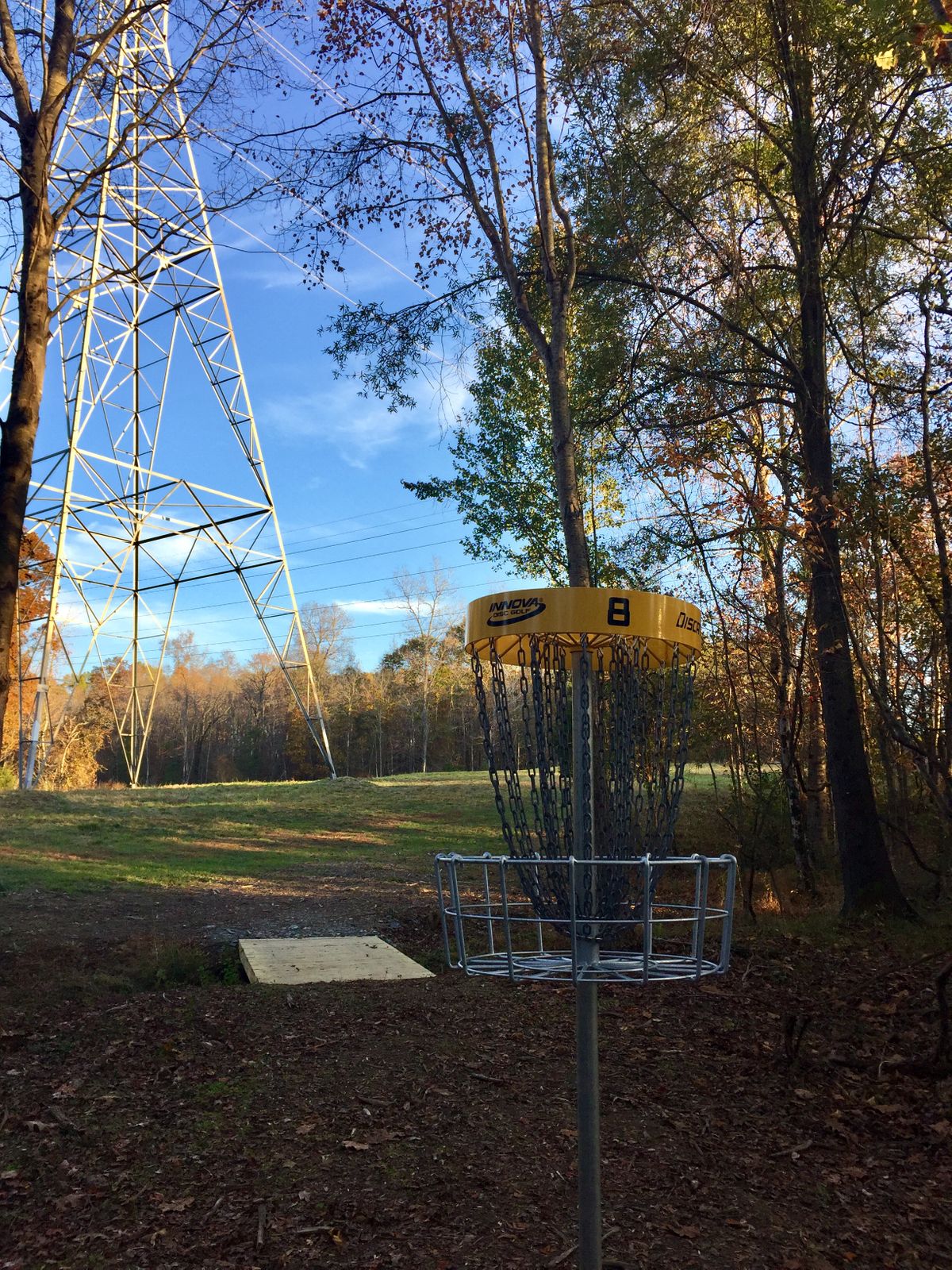 Elevated basket 8, looking up towards tee box on top of the hill to the right.