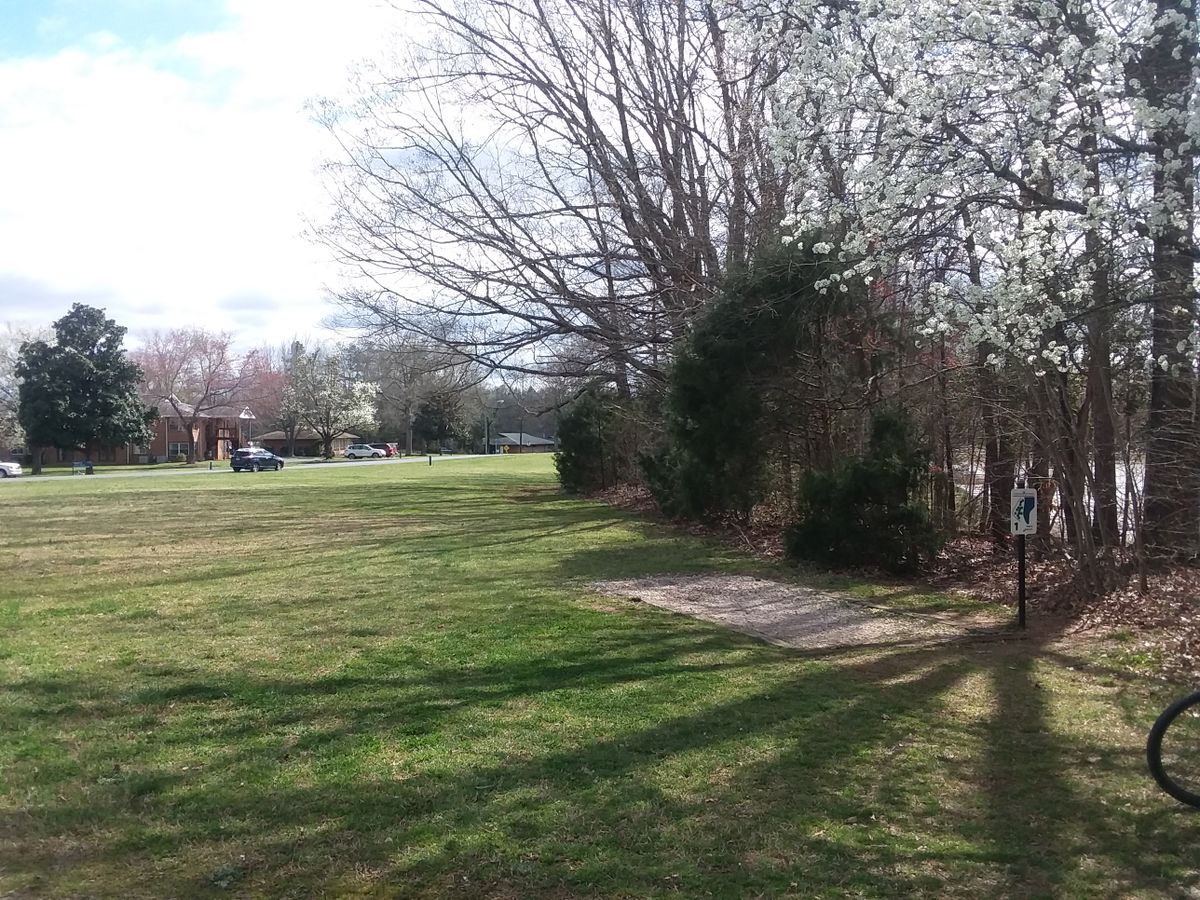 Hole one curves to the right around the trees.