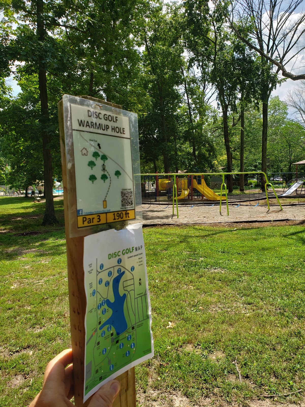 Practice hole Sign view of playground near swimming pool.