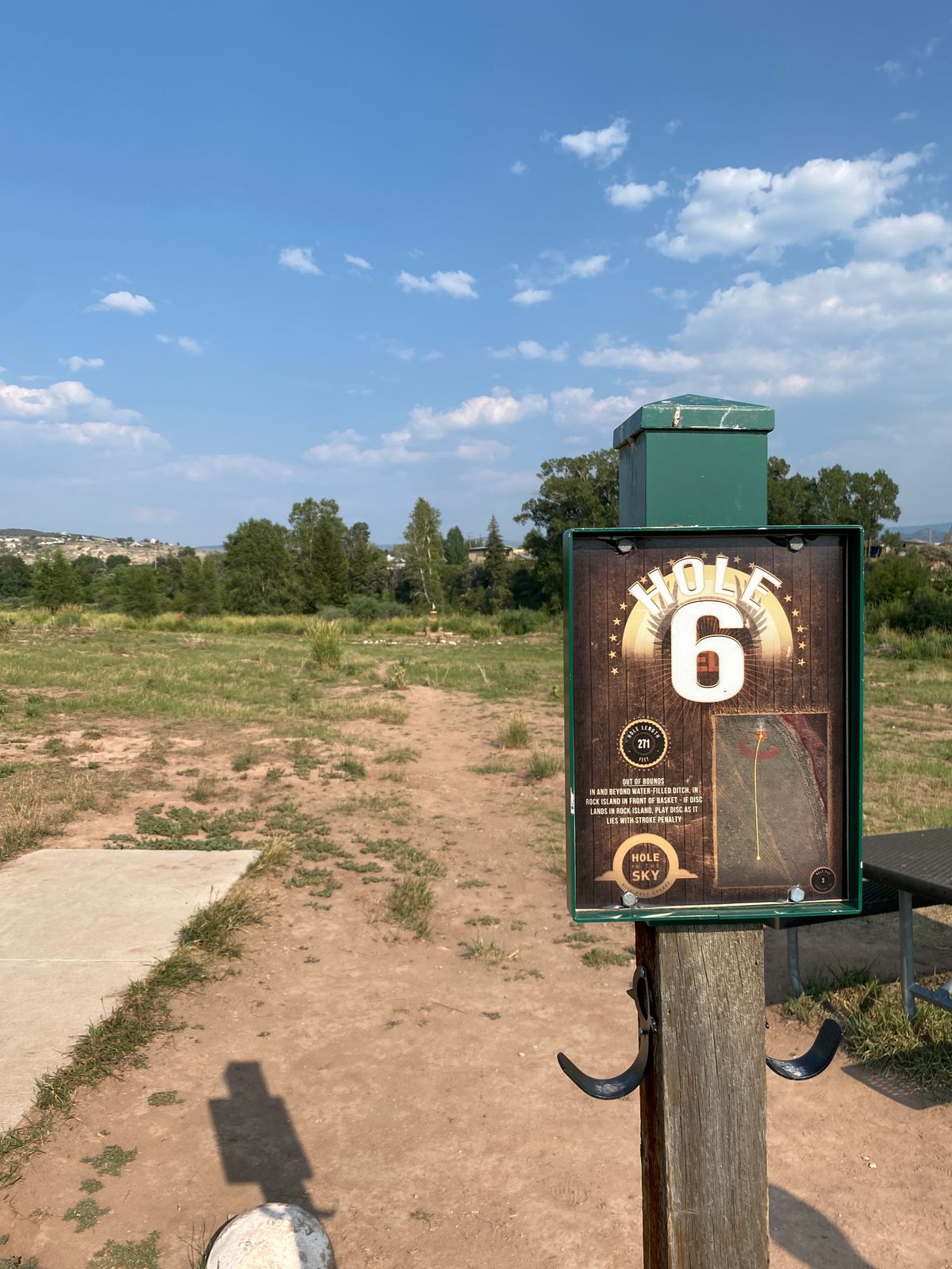 Tee sign with rules for the rock garden hazard on Hole 6.