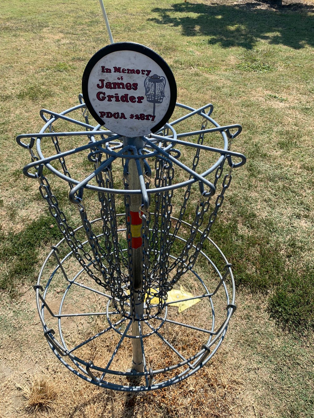 Hole 8’s basket w/arrow directing you to the next hole, over the bridge, to the left about 100 yards