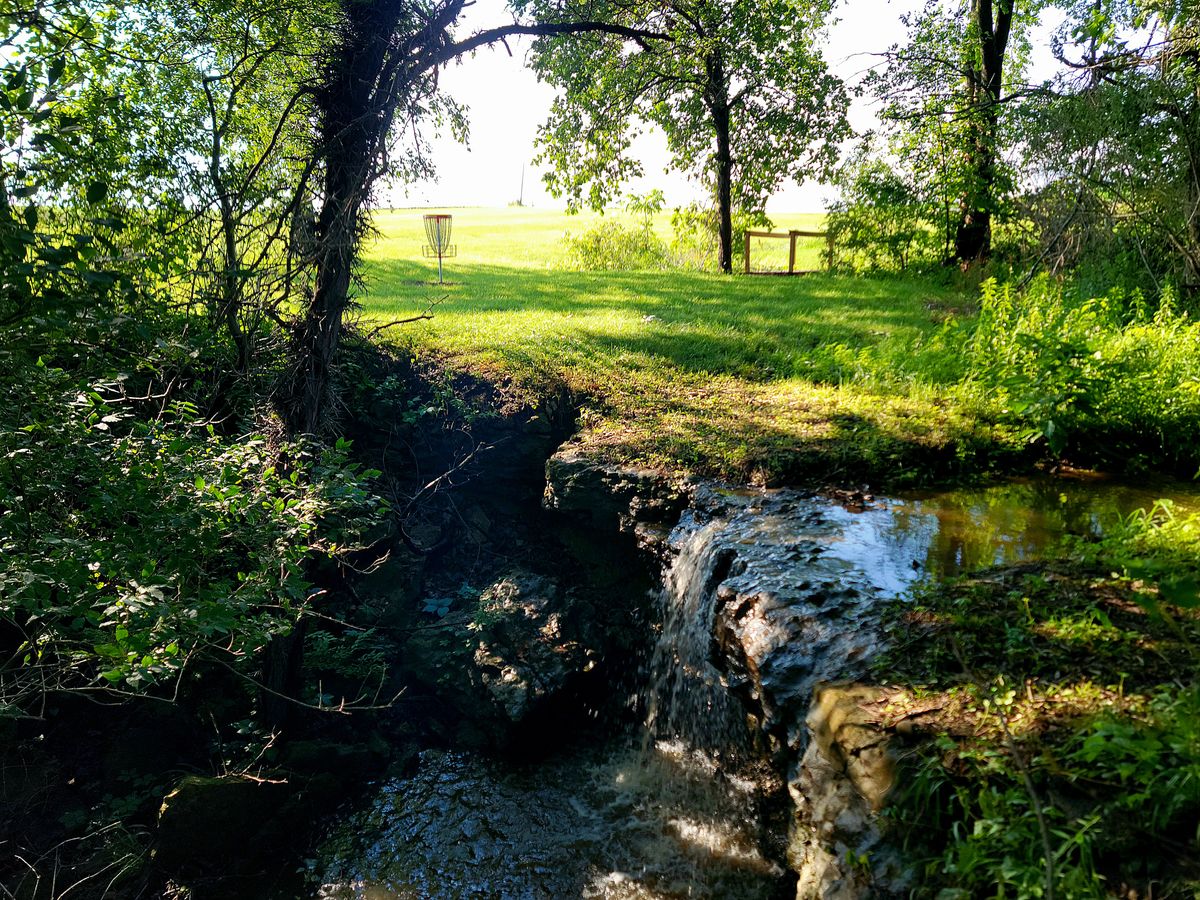 A waterfall that's behind hole 15's basket