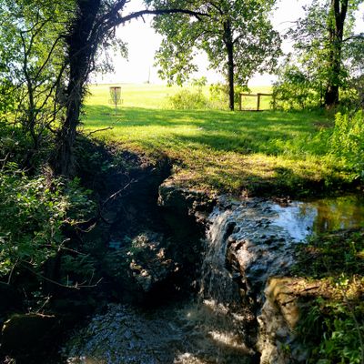 A waterfall that's behind hole 15's basket
