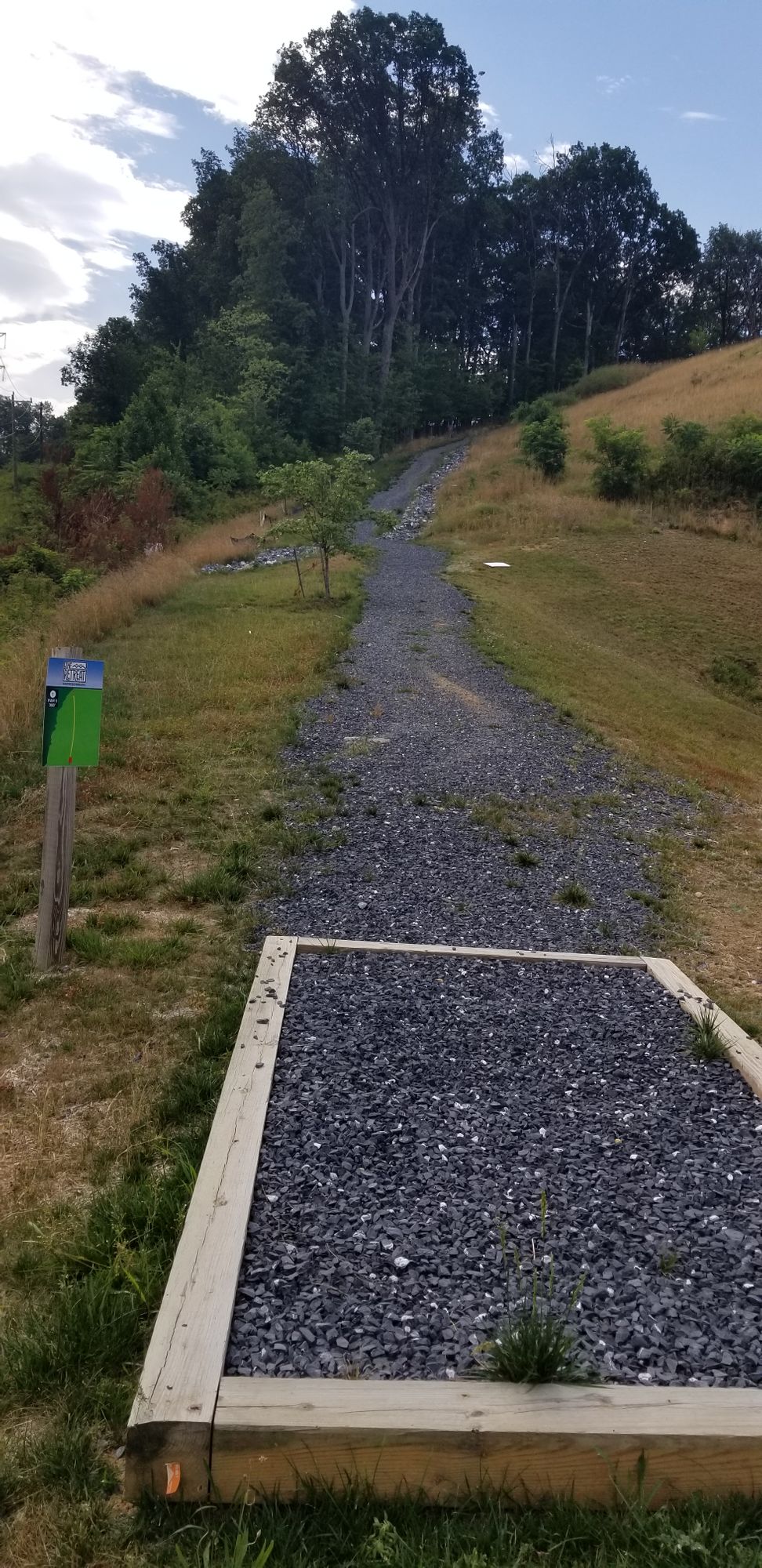 Tee box 1 looking uphill toward the basket.