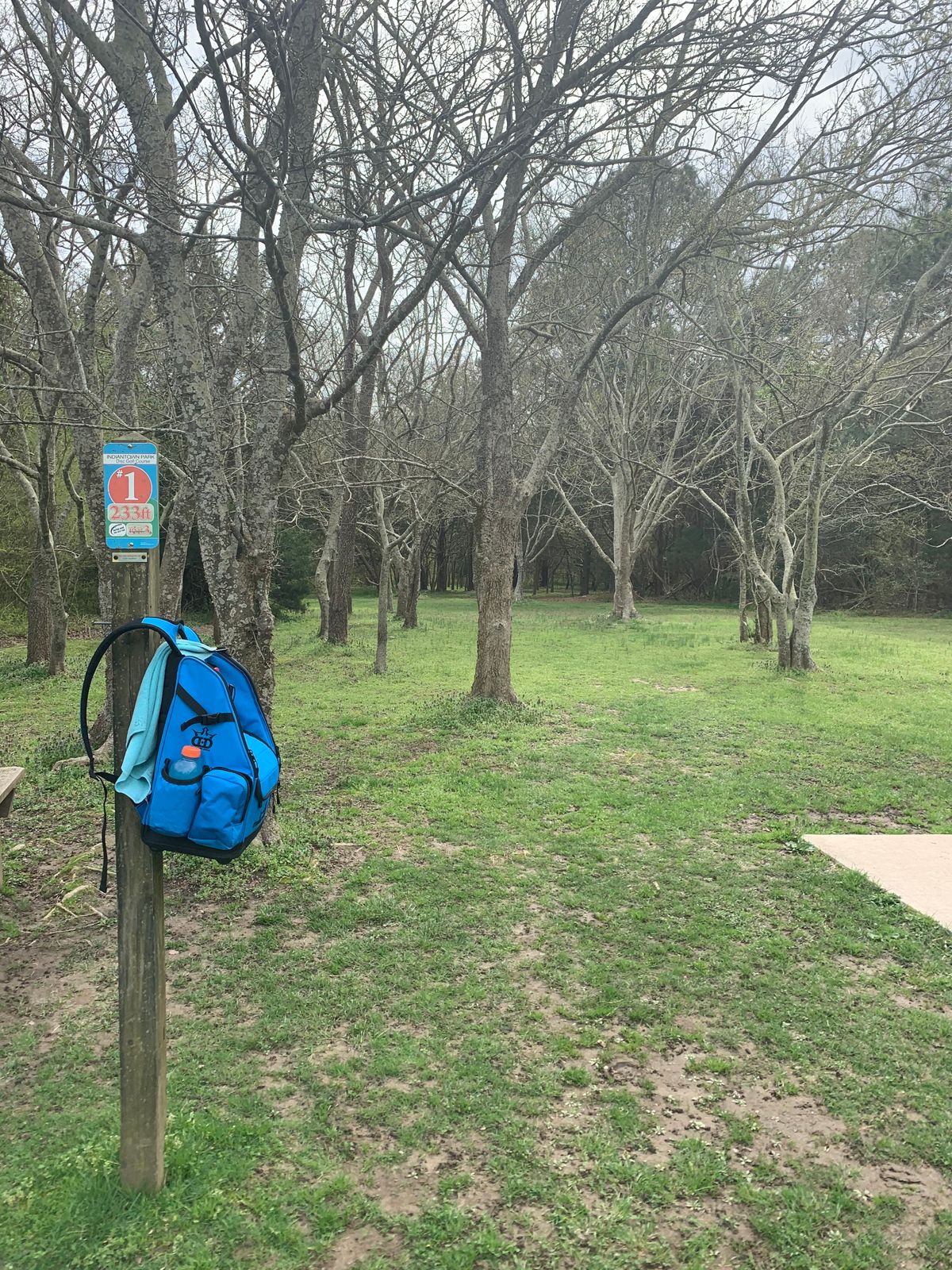 Hole 1 is to the right of the parking lot, between the kids park and  soccer goals.