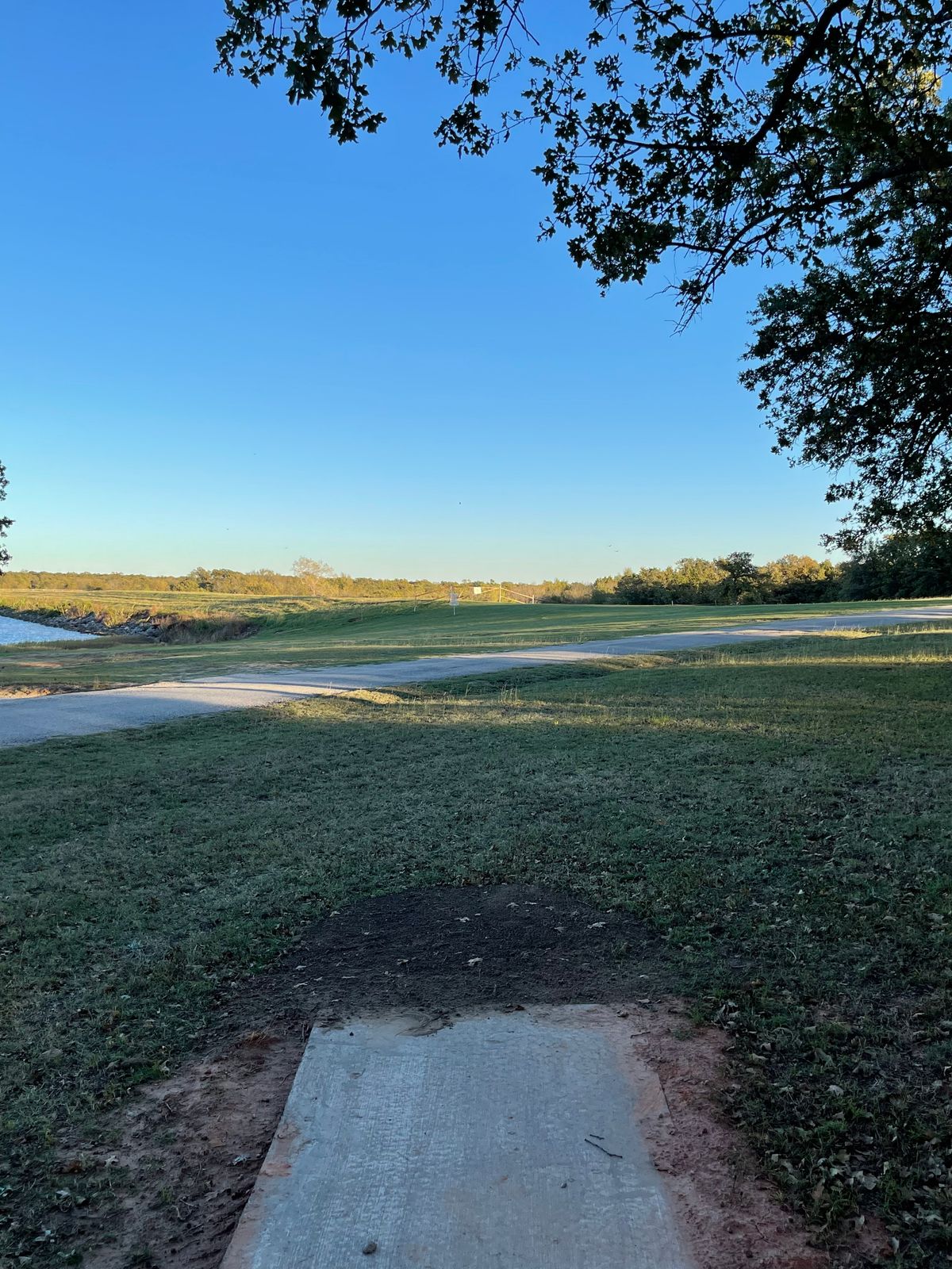 Hole 5: basket on the side of the dam, past the fence beyond basket is OB.
