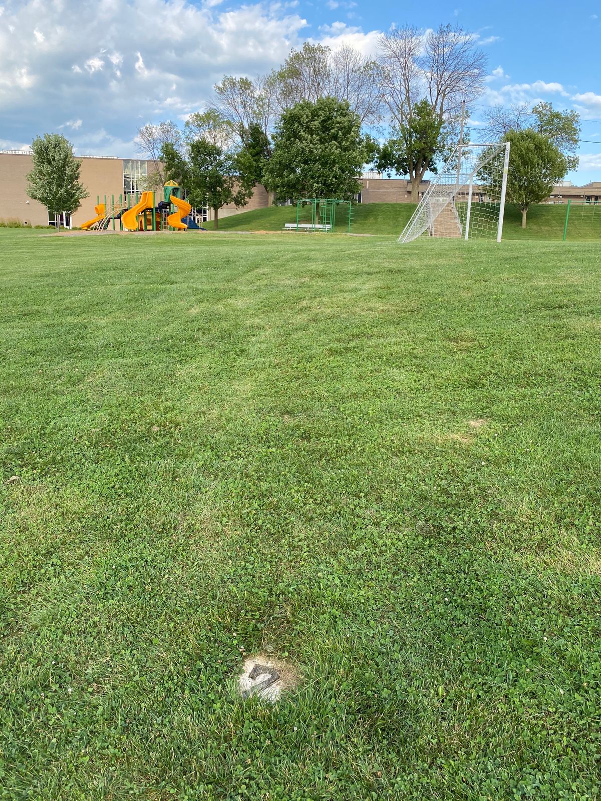 Hole #7 Basket is on hillside past playground.
