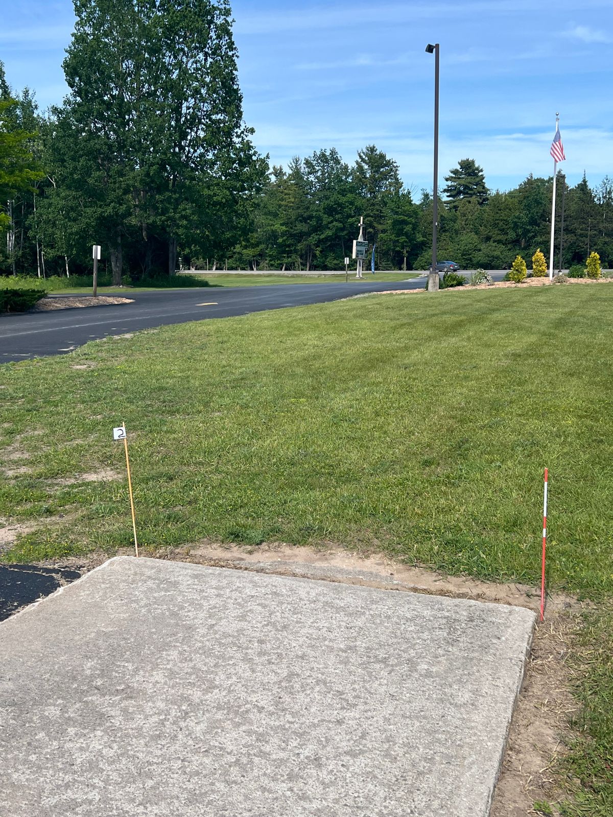 Tee pad 2 - Slight dogleg left unless you go over the trees. “Tee” is the end of the sidewalk by the lower level parking lot.