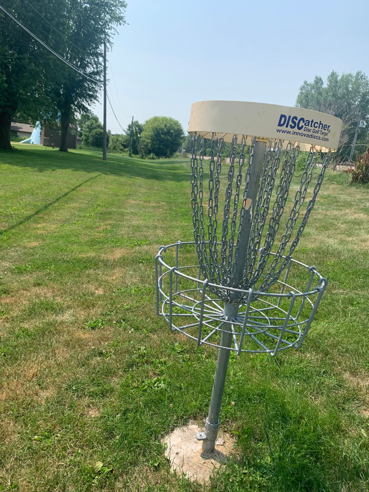 View of hole 4 basket along the railroad tracks looking back towards tee pad.
