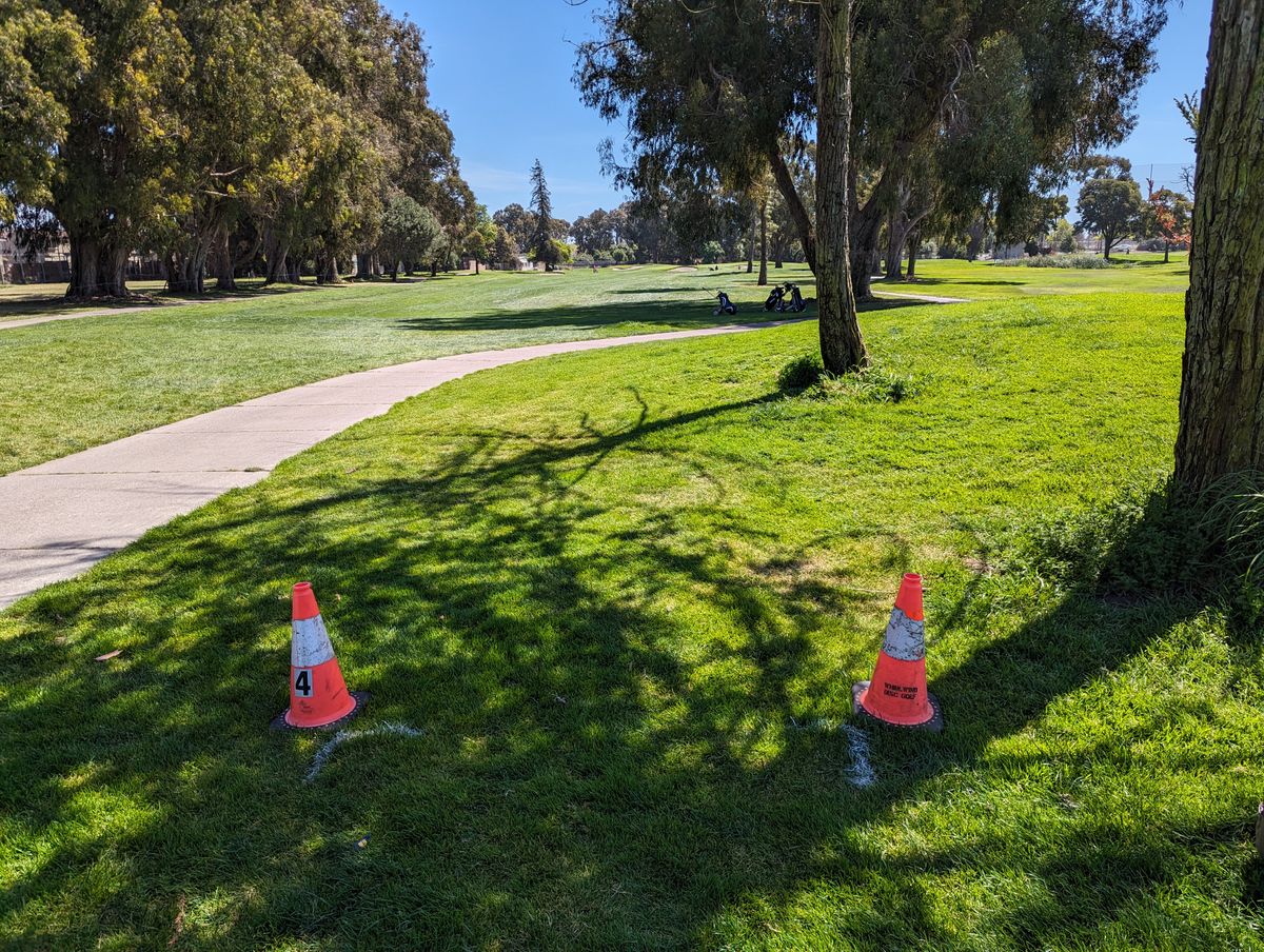 Tee areas are marked with cones and sometimes painted corners too. They can be moved by groundskeepers or other folks.