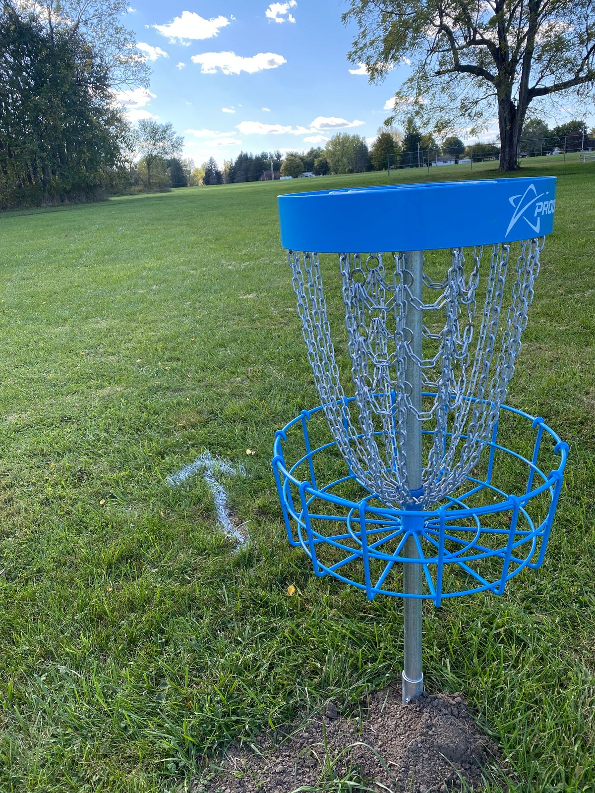 Directional arrow painted on grass after first basket