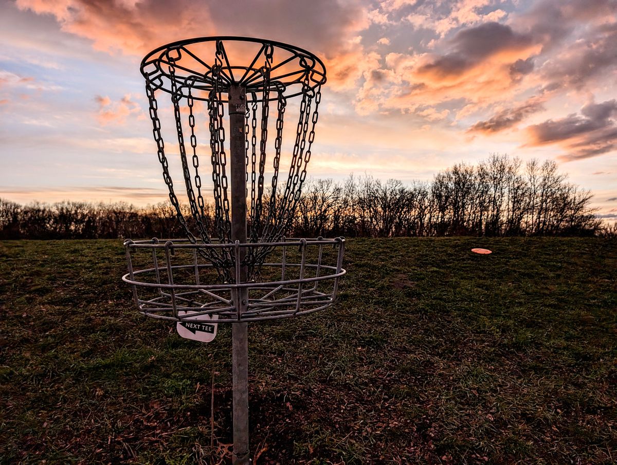 Hole 18 short basket beautiful post rain sunset