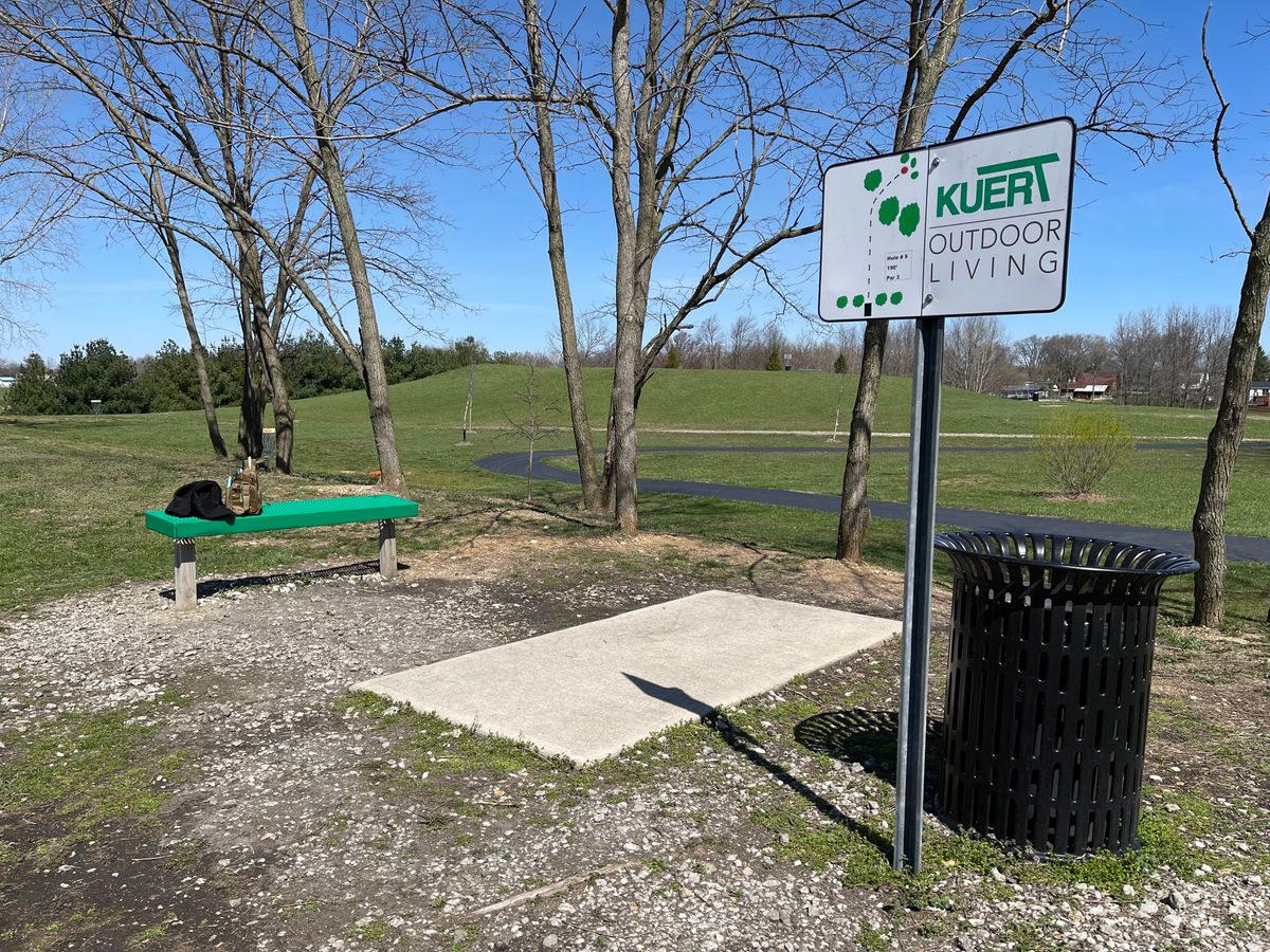 Every hole has a concrete pad or is part of the walking path, a bench, and a trash can. Very cool.