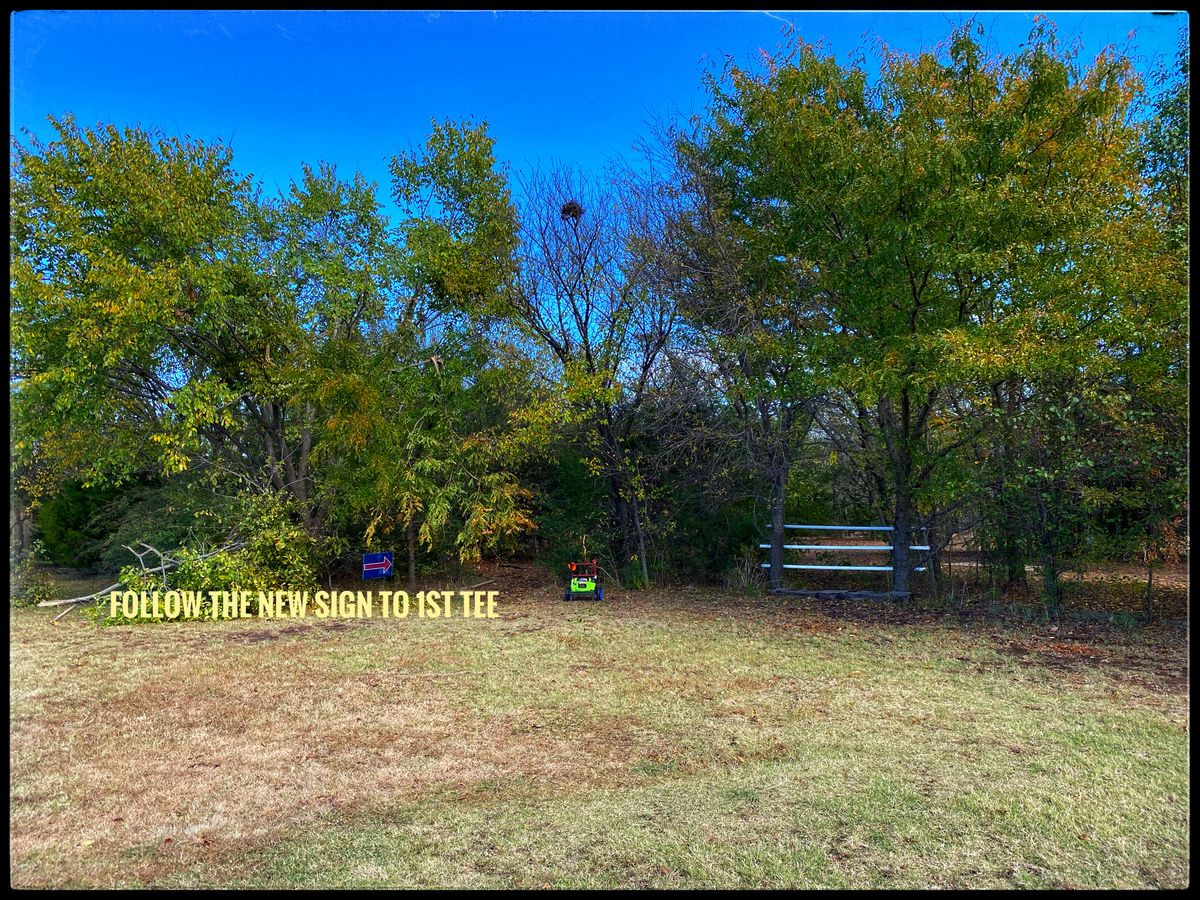 Look for the white fence and sign to path to 1st Tee.