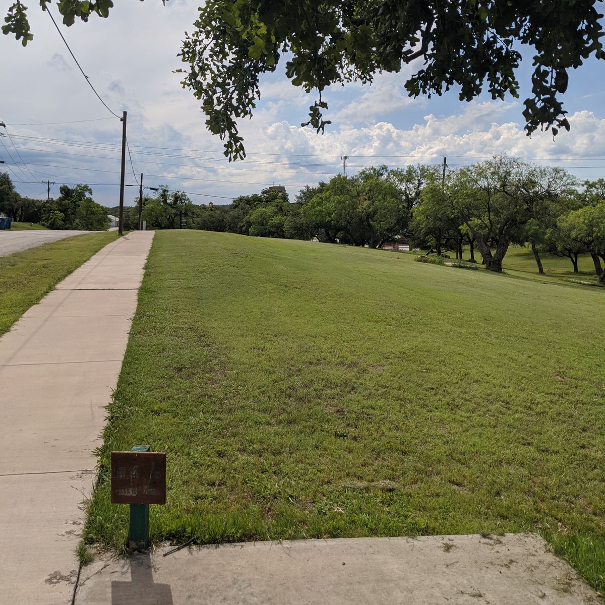 Hole 4 from the tee. The basket is located along the tree line to the right under a mesquite tree.