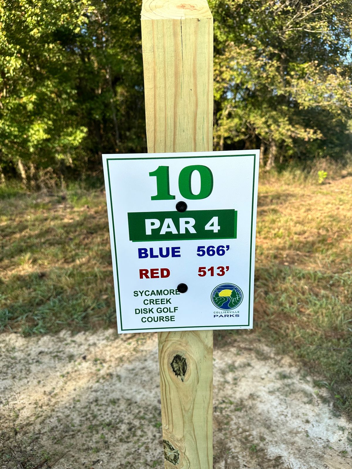 Basket is 290’ straight then dogleg left into woods and up hill