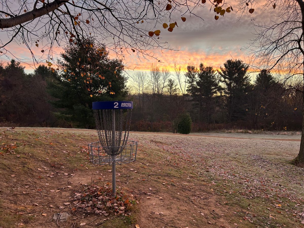 Hole 2 basket with sunrise and frost