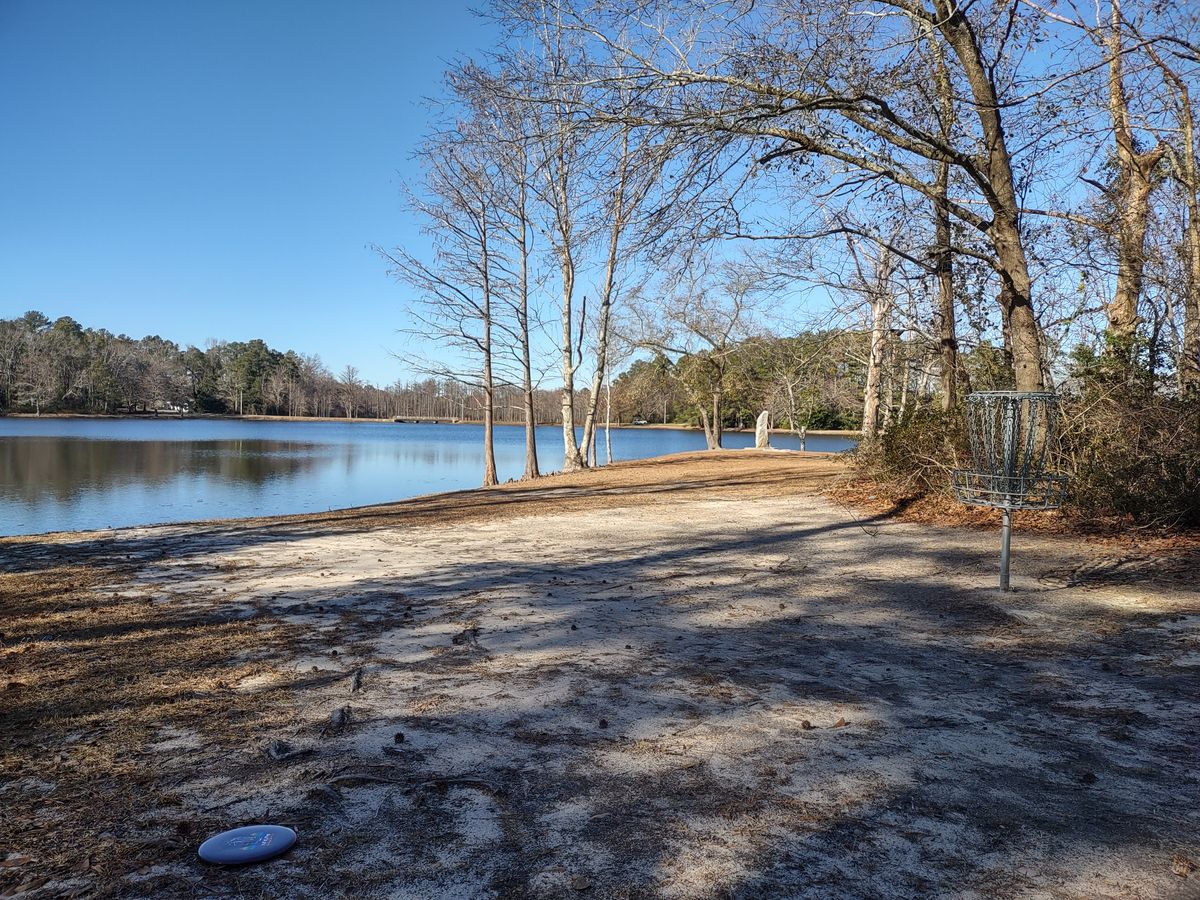 Hole 18 features a beautiful lake view behind the pin.