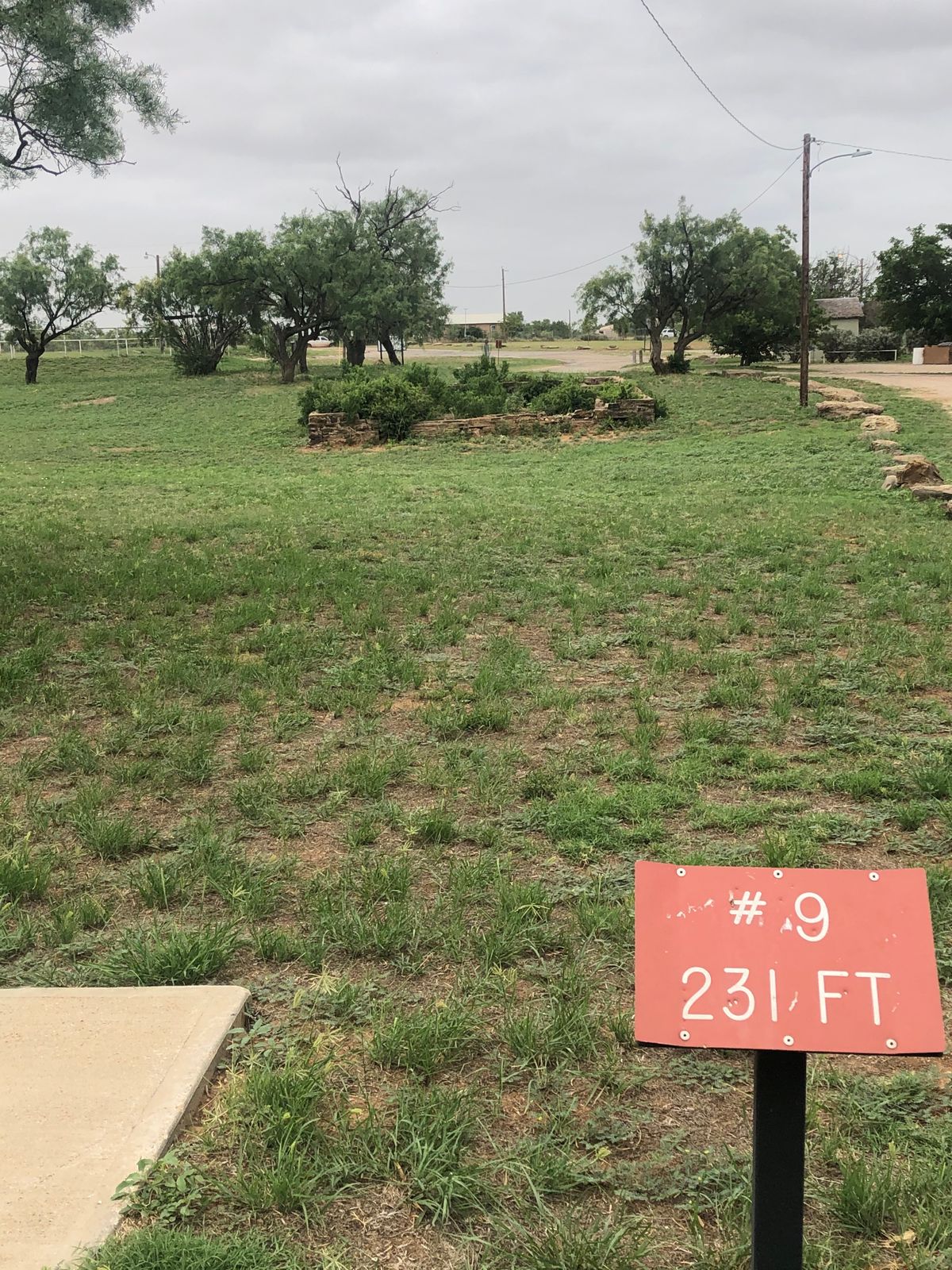 #9 tee pad with entrance to park and park pavilion on the right!