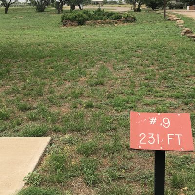 #9 tee pad with entrance to park and park pavilion on the right!