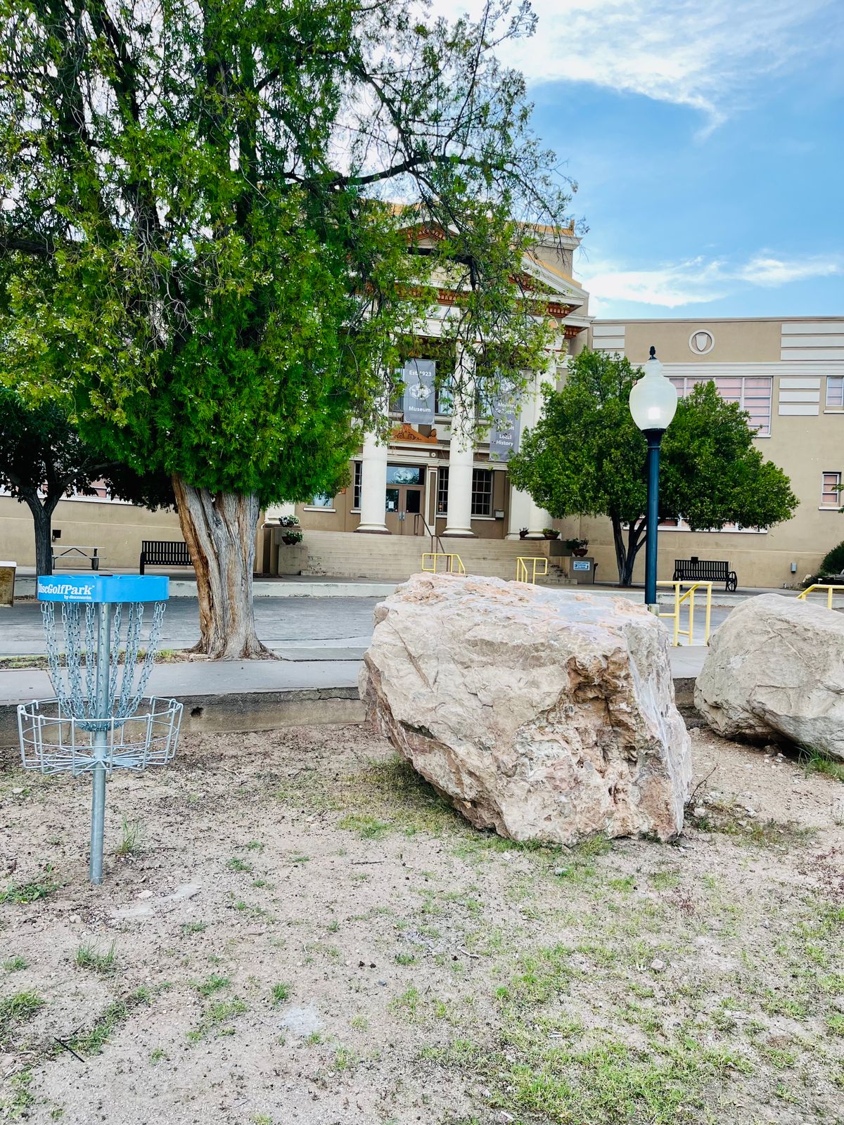Hole 1 basket with Bullion Plaza Museum in view. Boulders are from an old drilling competition.