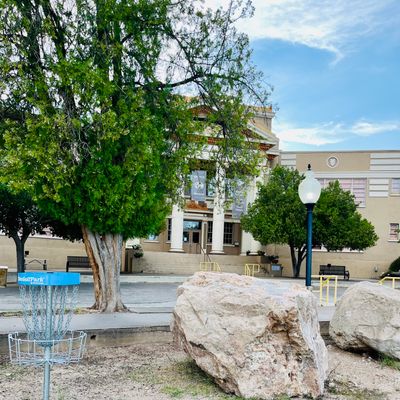 Hole 1 basket with Bullion Plaza Museum in view. Boulders are from an old drilling competition.