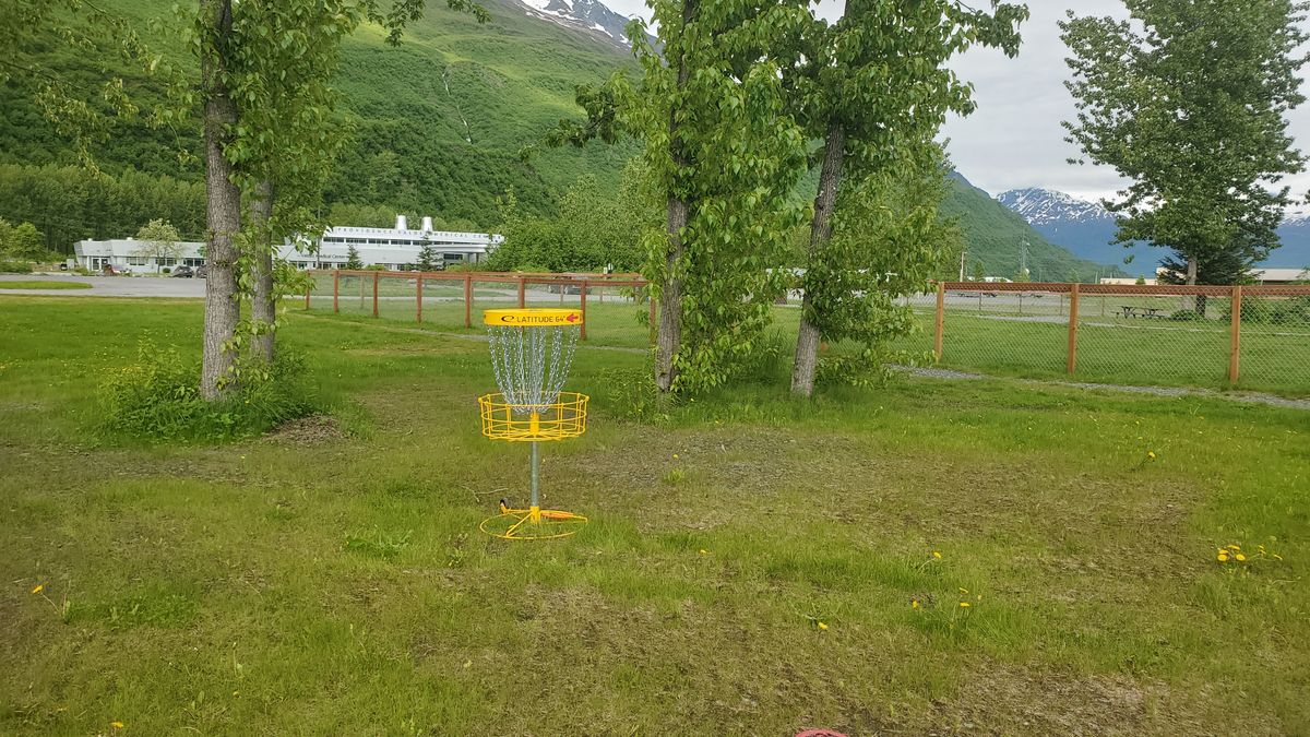 Hole two tucked between trees on the greenbelt