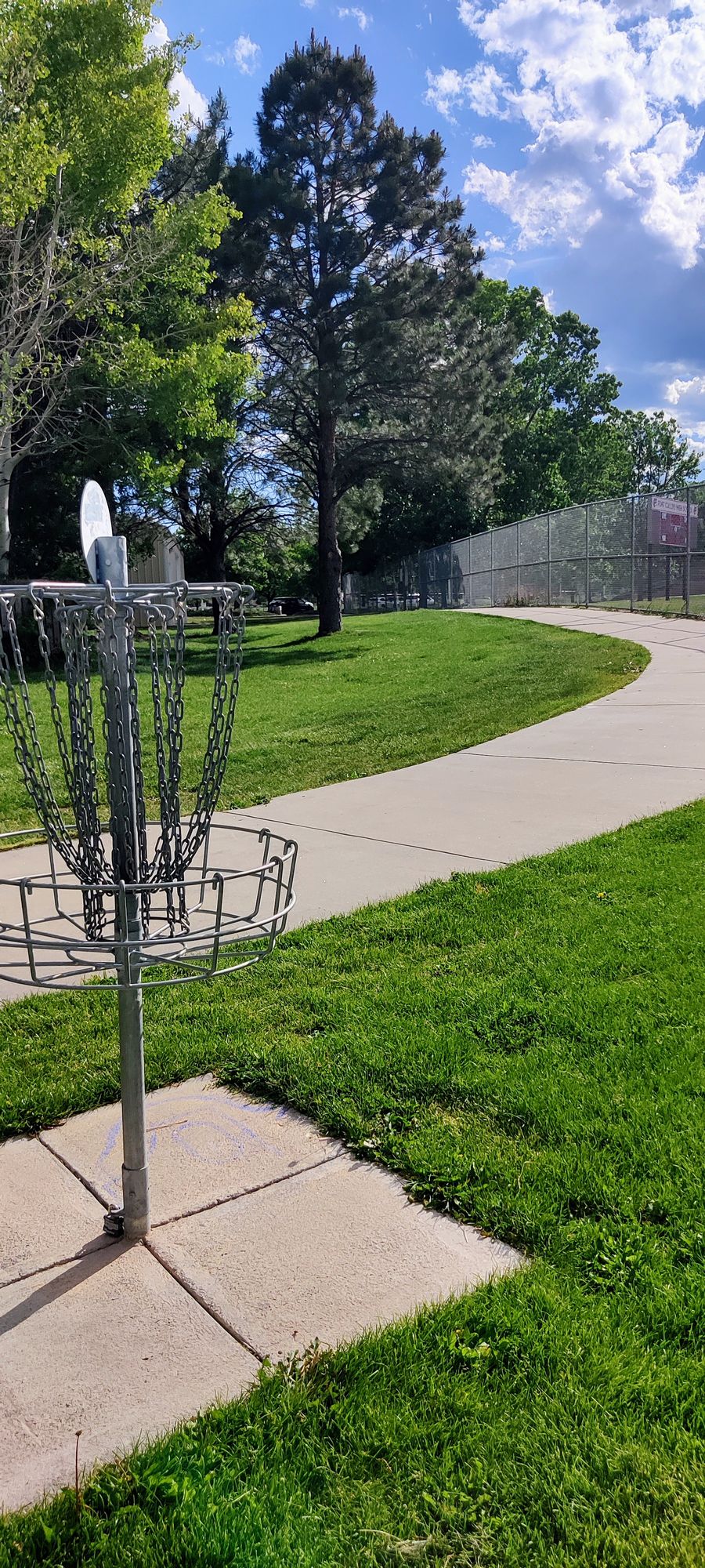 Hole 10 basket - keep walking on sidewalk and turn right after fence to get to hole 11