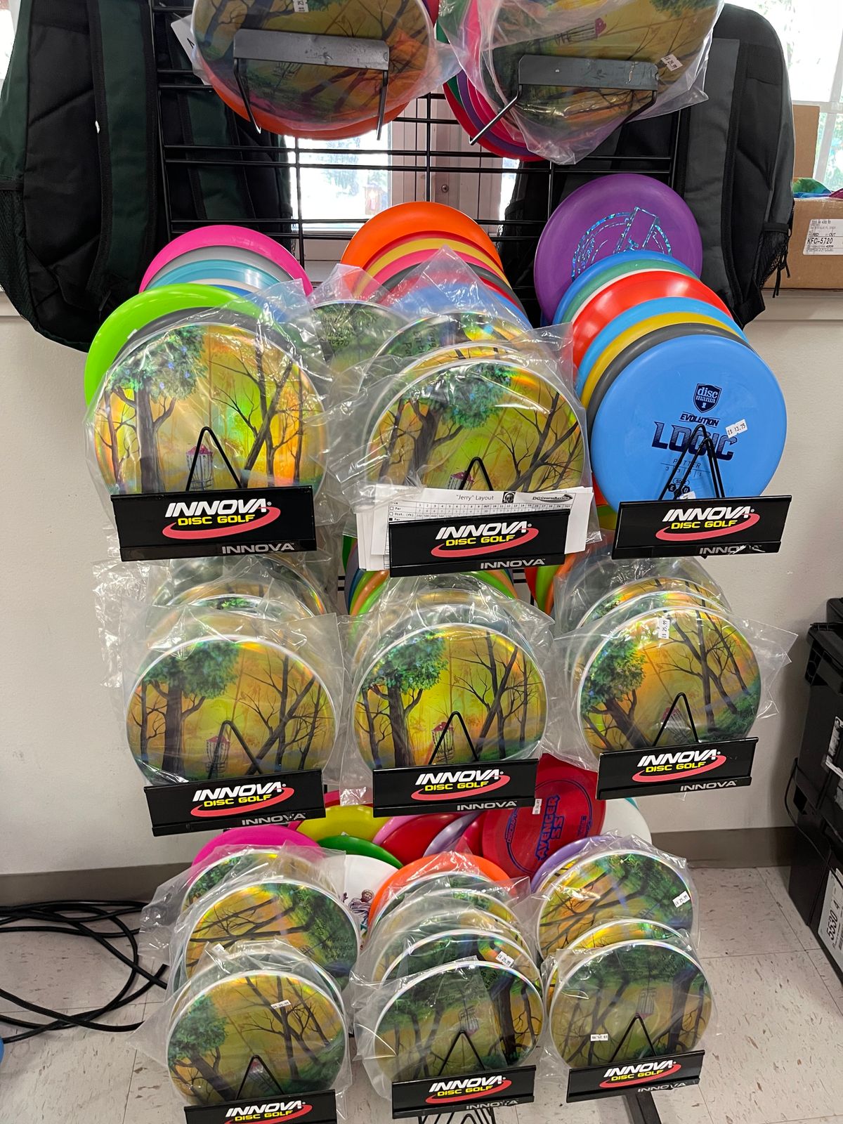 Rack of discs in the store. Mostly discraft, some disc mania, innova