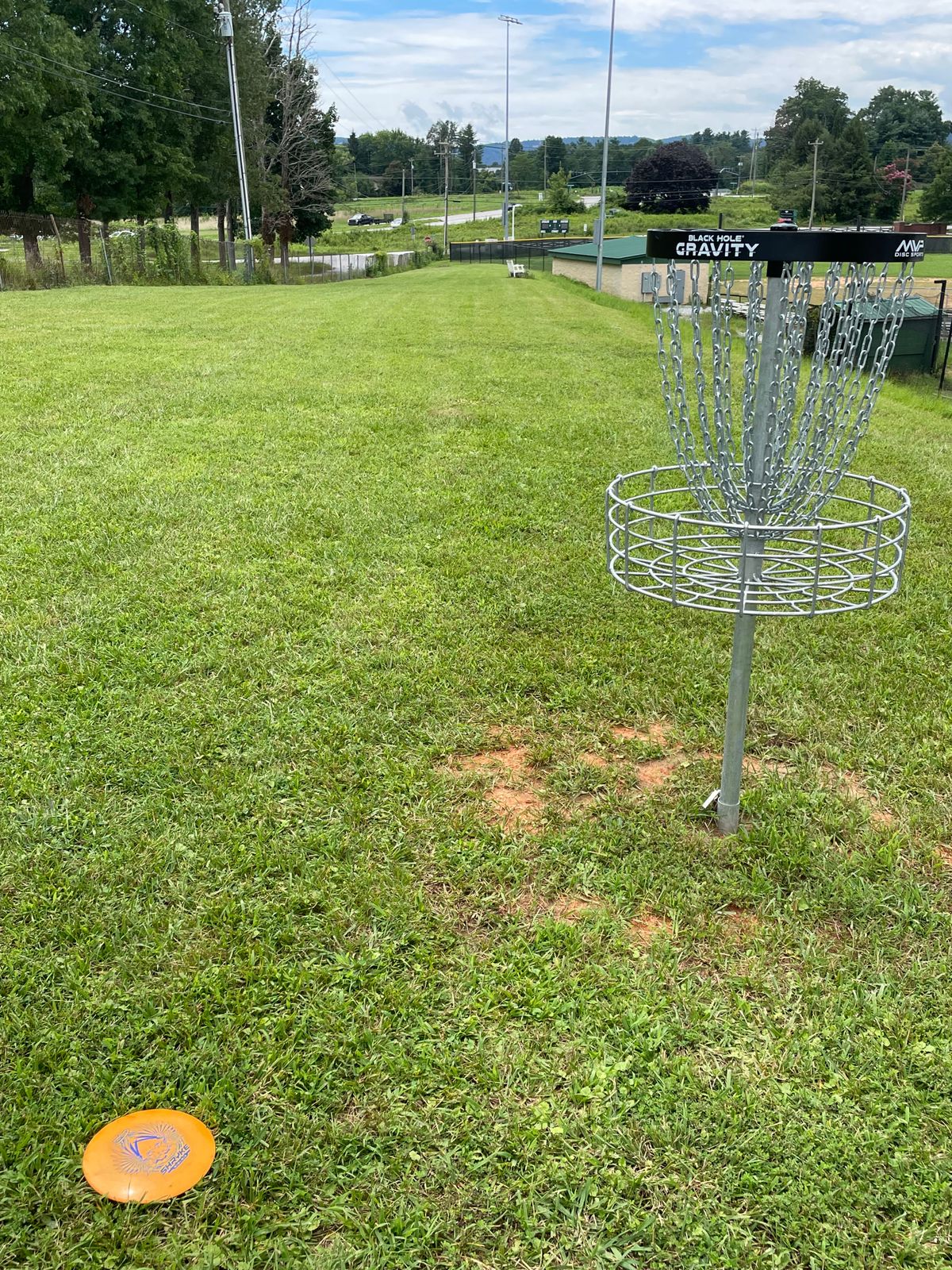 Hole 3’s basket back down fairway to tee between fences