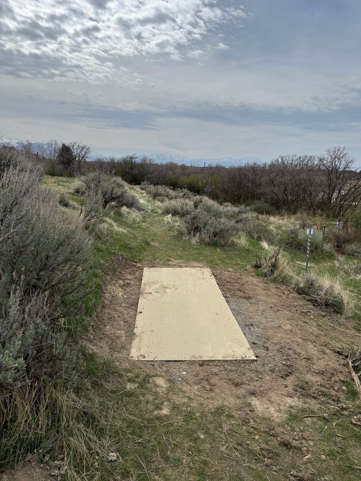 Hole 13 - new concrete fiber pad replaces dirt pad