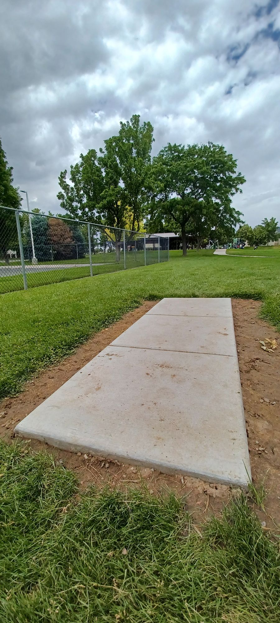 9th Tee Platform. Basket is off to the left of platform. On the other side of the fence by pavilion with the tables. Walking path, playground & pavilion close area so please watch out for others.

*This is the 18th hole as well, if you are using the 18 hole scorecard.