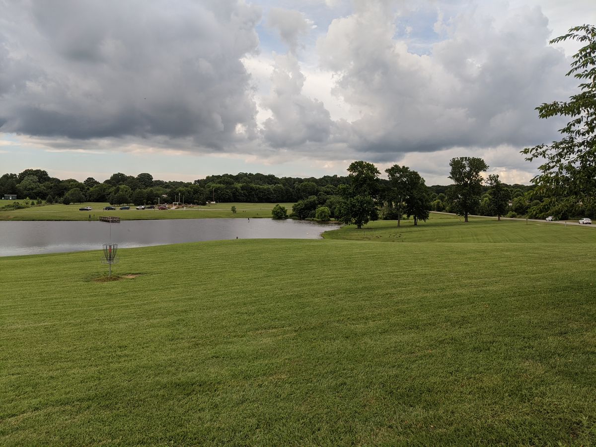 Practice basket, and first fairway along the edge of the pond.