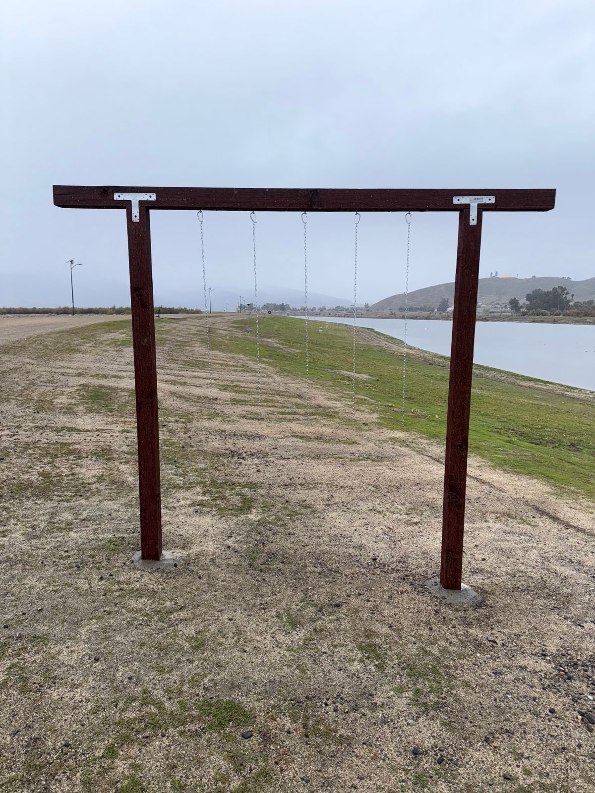 HOLE 5 TEE PAD, "THE CHAIN SWING" - MANDATORY THROUGH THE SWING - RE-TEE, TAKE A PENALTY EACH TIME MISSED.