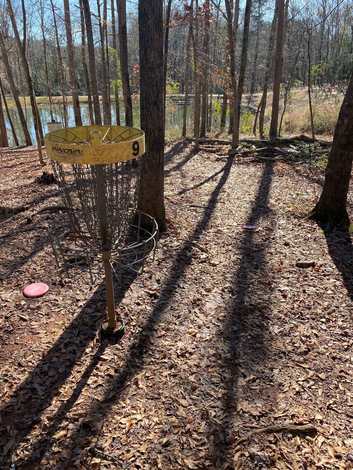 Hole 9 basket. Hole 7 basket is out of picture to the left. Hole 5 basket is across the lake.